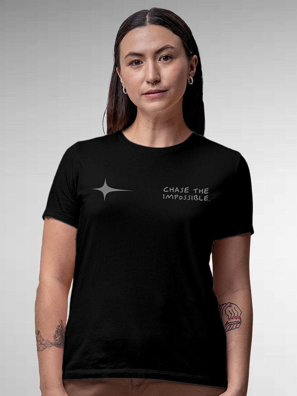 Model wearing Women's Black Round Neck T-shirt with 'Chase The Impossible' design, offering effortless style and premium comfort