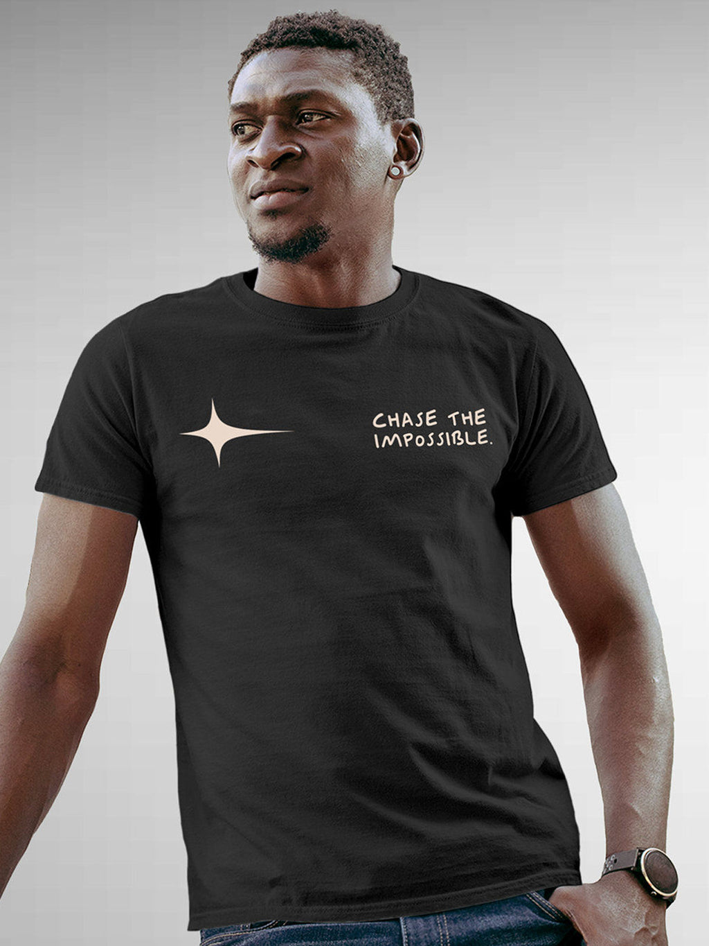 Model wearing Men's Dark Grey Round Neck T-shirt with 'Chase The Impossible' design, offering effortless style and premium comfort