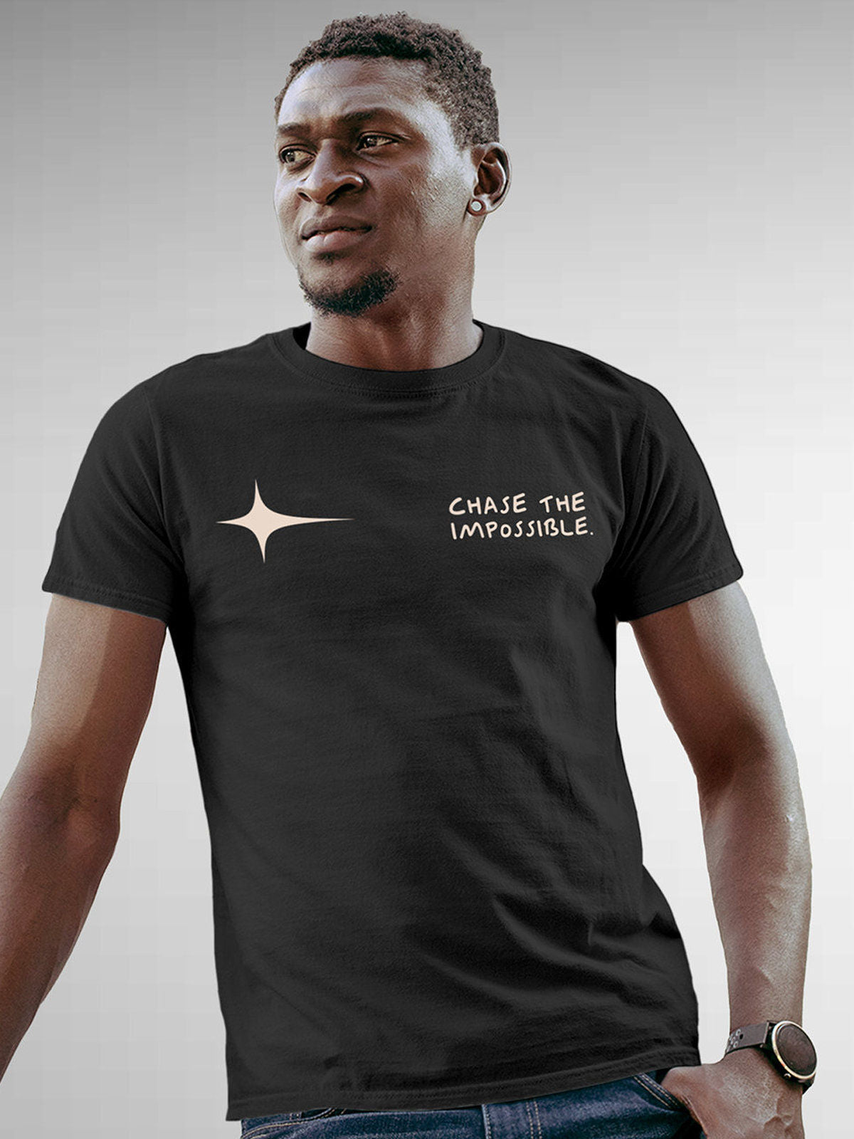 Model wearing Men's Dark Grey Round Neck T-shirt with 'Chase The Impossible' design, offering effortless style and premium comfort