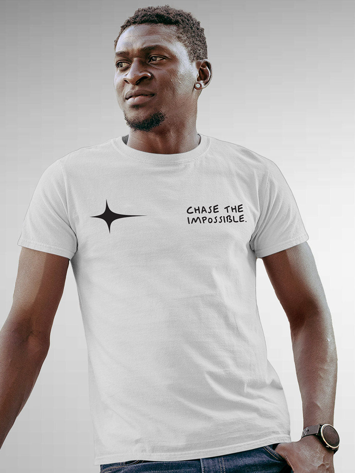 Model wearing Men's White Round Neck T-shirt with 'Chase The Impossible' design, offering effortless style and premium comfort