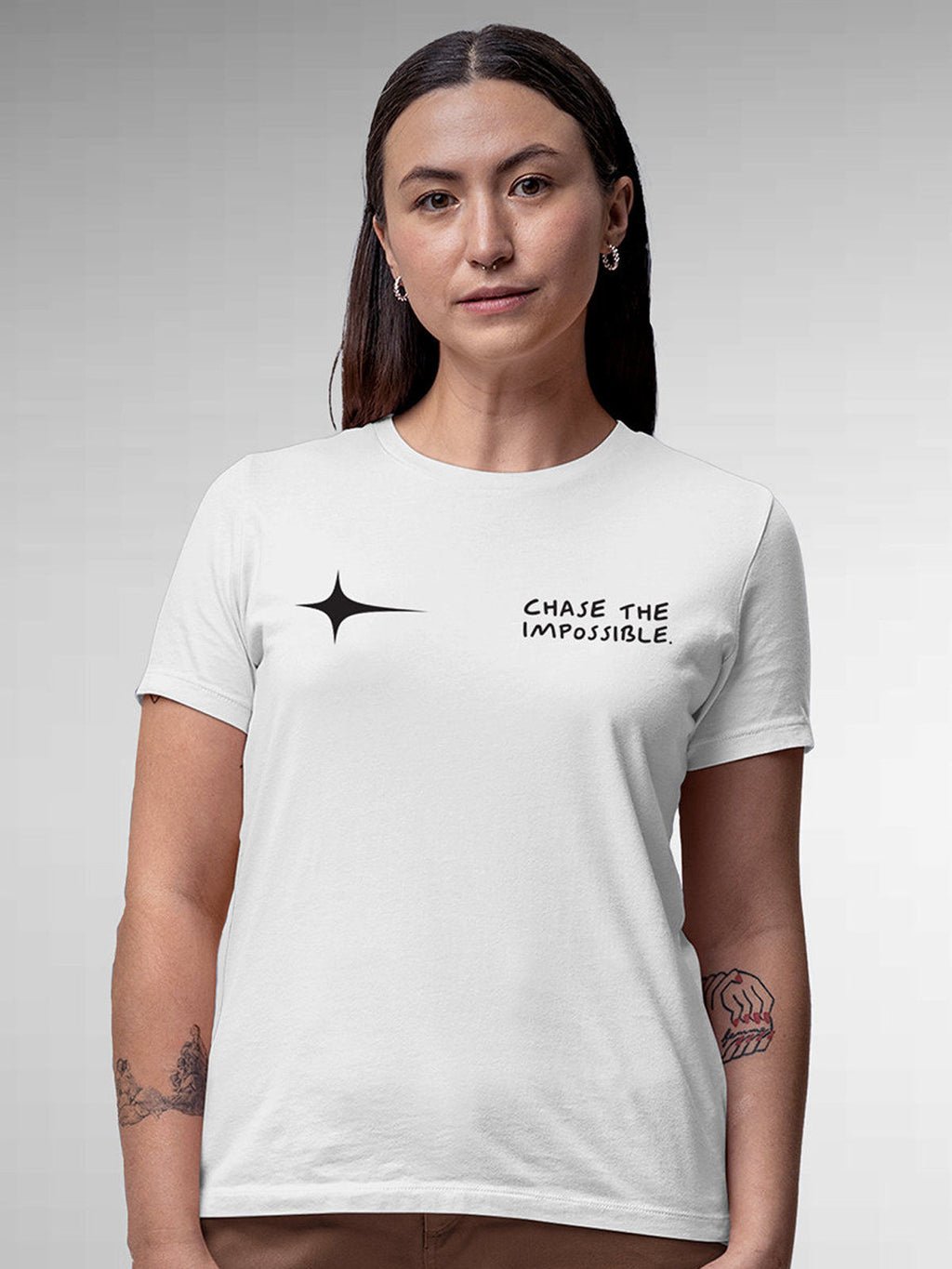 Model wearing Women's White Round Neck T-shirt with 'Chase The Impossible' design, offering effortless style and premium comfort
