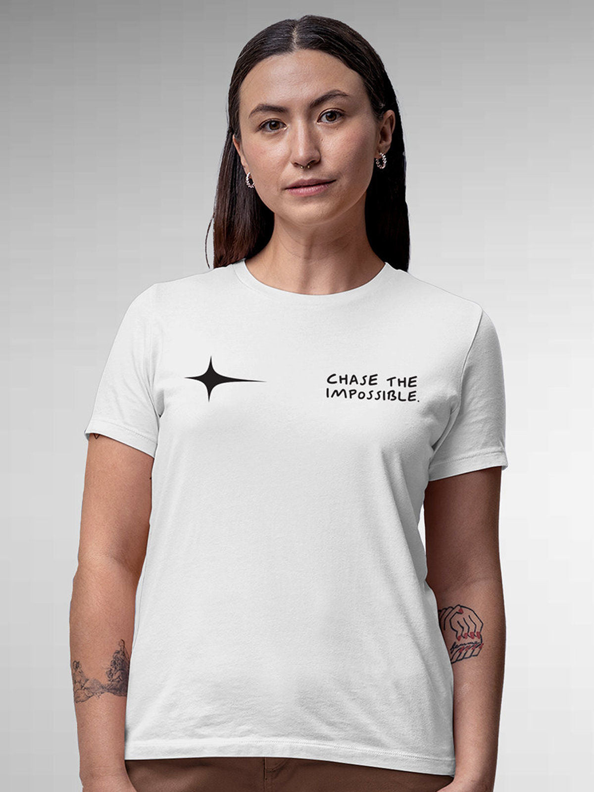 Model wearing Women's White Round Neck T-shirt with 'Chase The Impossible' design, offering effortless style and premium comfort