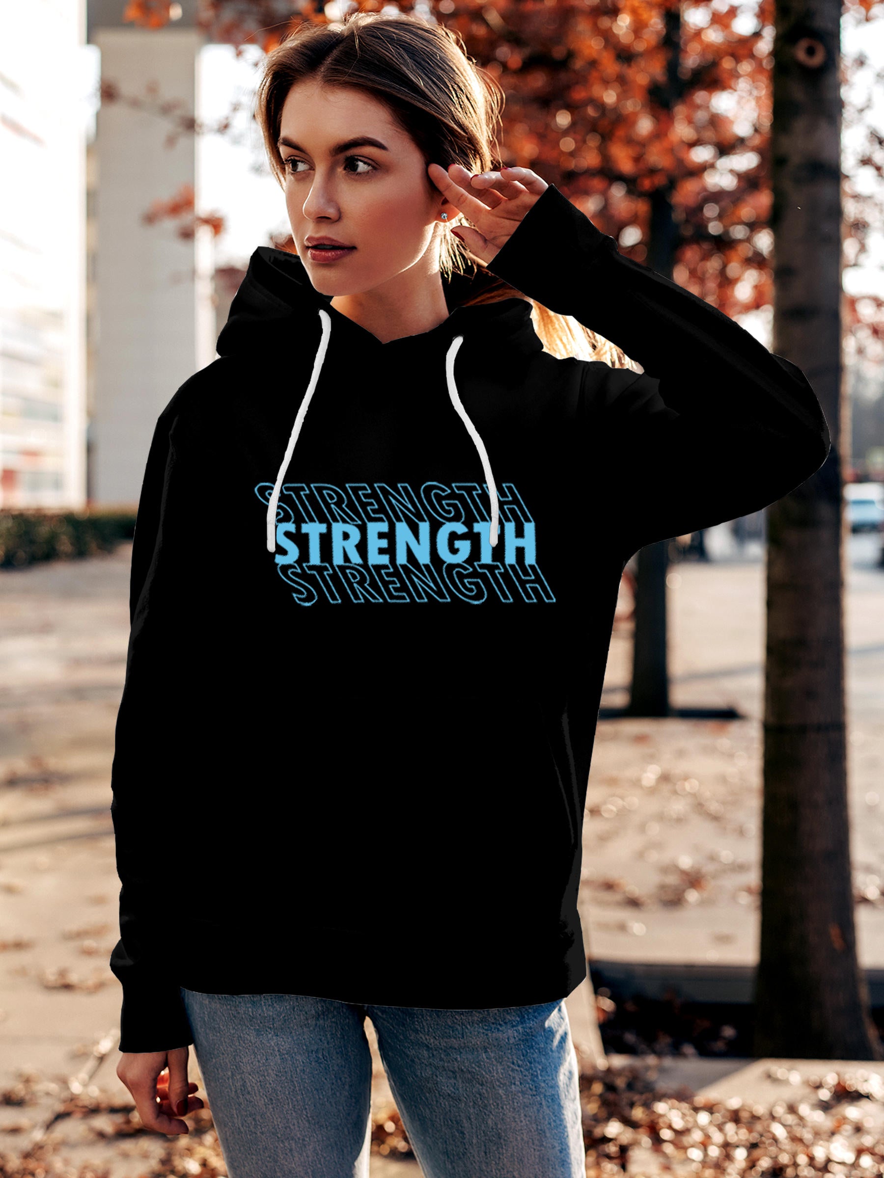 Model wearing Women's Black Hoodie Sweatshirt with 'Strength' design, offering effortless style and premium comfort