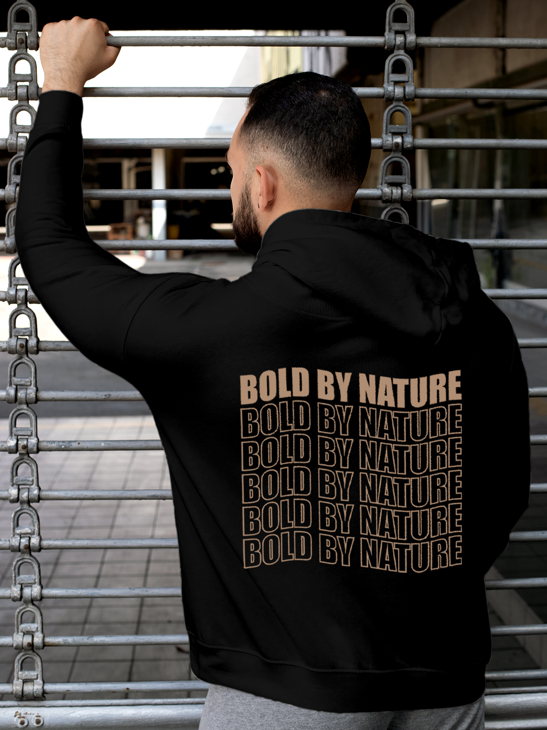 Model wearing Men's Black Hoodie Sweatshirt with 'Bold By Nature' design, offering effortless style and premium comfort