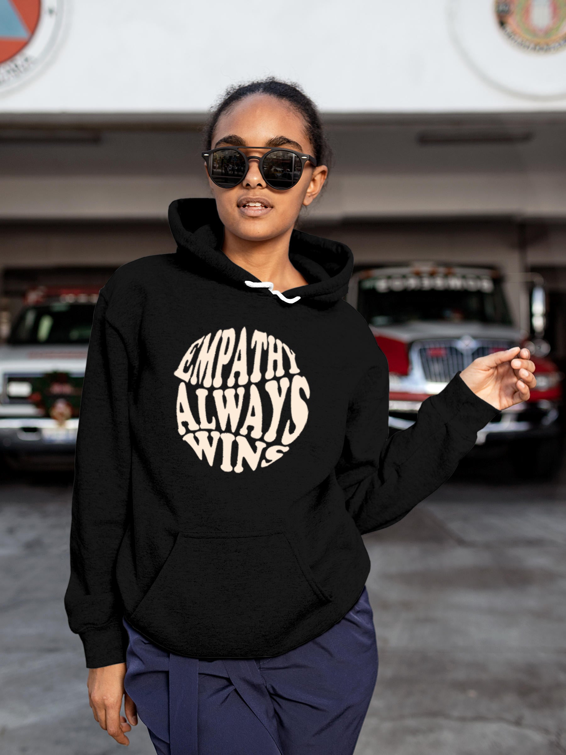 Model wearing Women's Black Hoodie Sweatshirt with 'Empathy Always Wins' design, offering effortless style and premium comfort