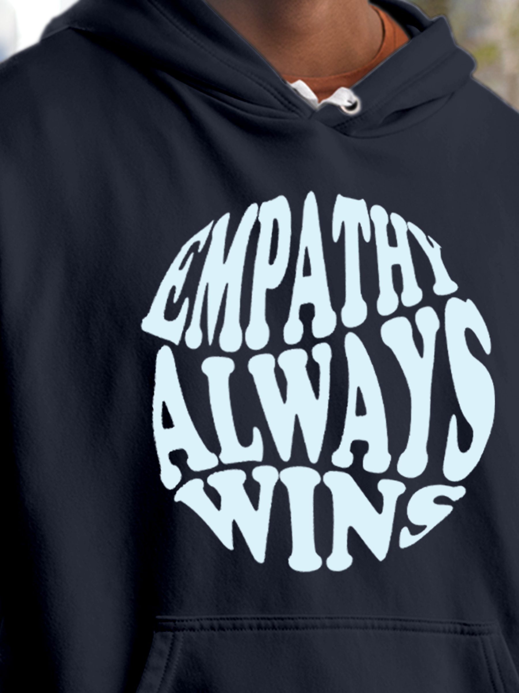 Close up of 'Empathy Always Wins' design on Men's Navy Blue Hoodie Sweatshirt, highlighting intricate details and vibrant print.