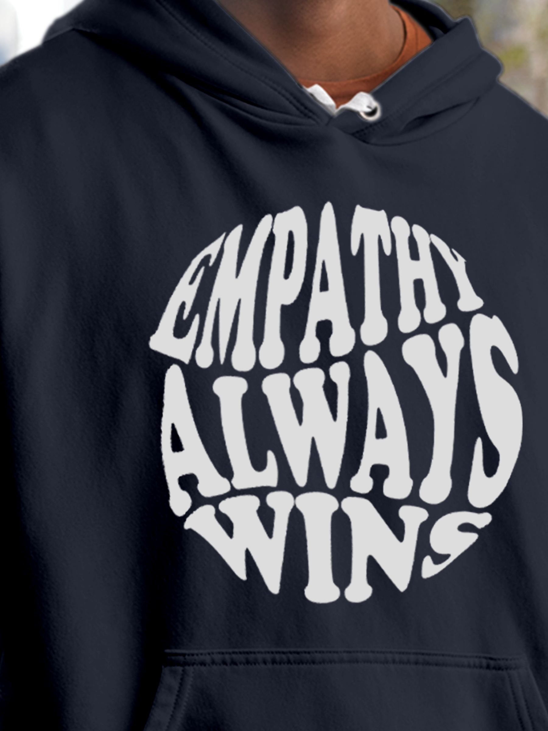 Close up of 'Empathy Always Wins' design on Men's Navy Blue Hoodie Sweatshirt, highlighting intricate details and vibrant print.