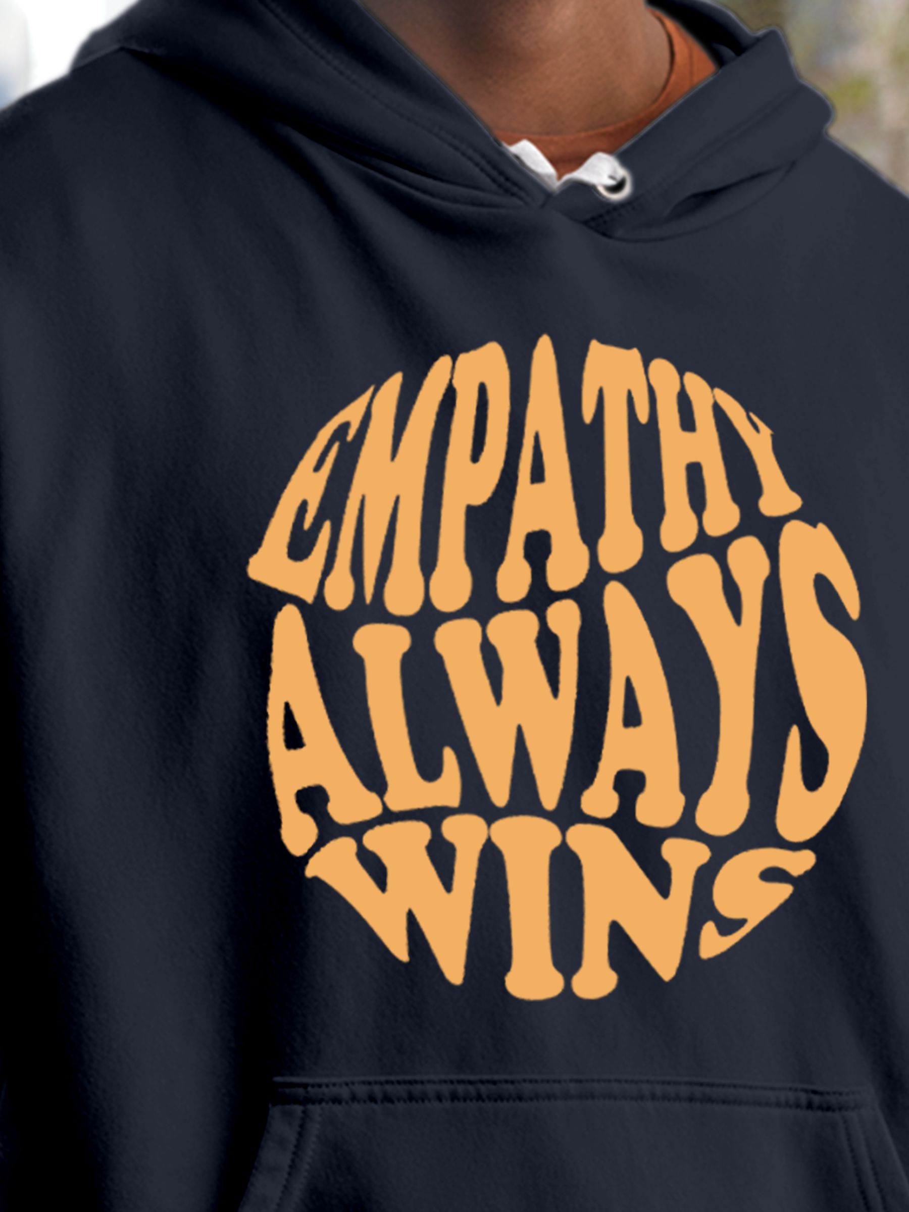 Close up of 'Empathy Always Wins' design on Men's Navy Blue Hoodie Sweatshirt, highlighting intricate details and vibrant print.