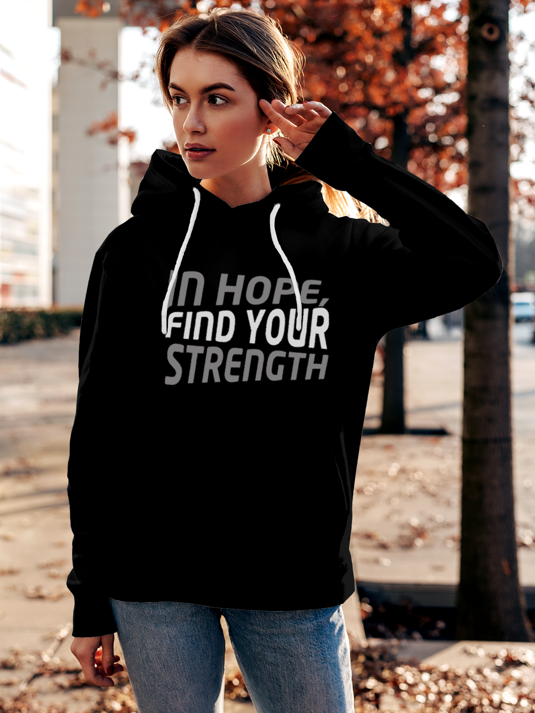Model wearing Women's Black Hoodie Sweatshirt with 'In Hope, Find Your Strength' design, offering effortless style and premium comfort