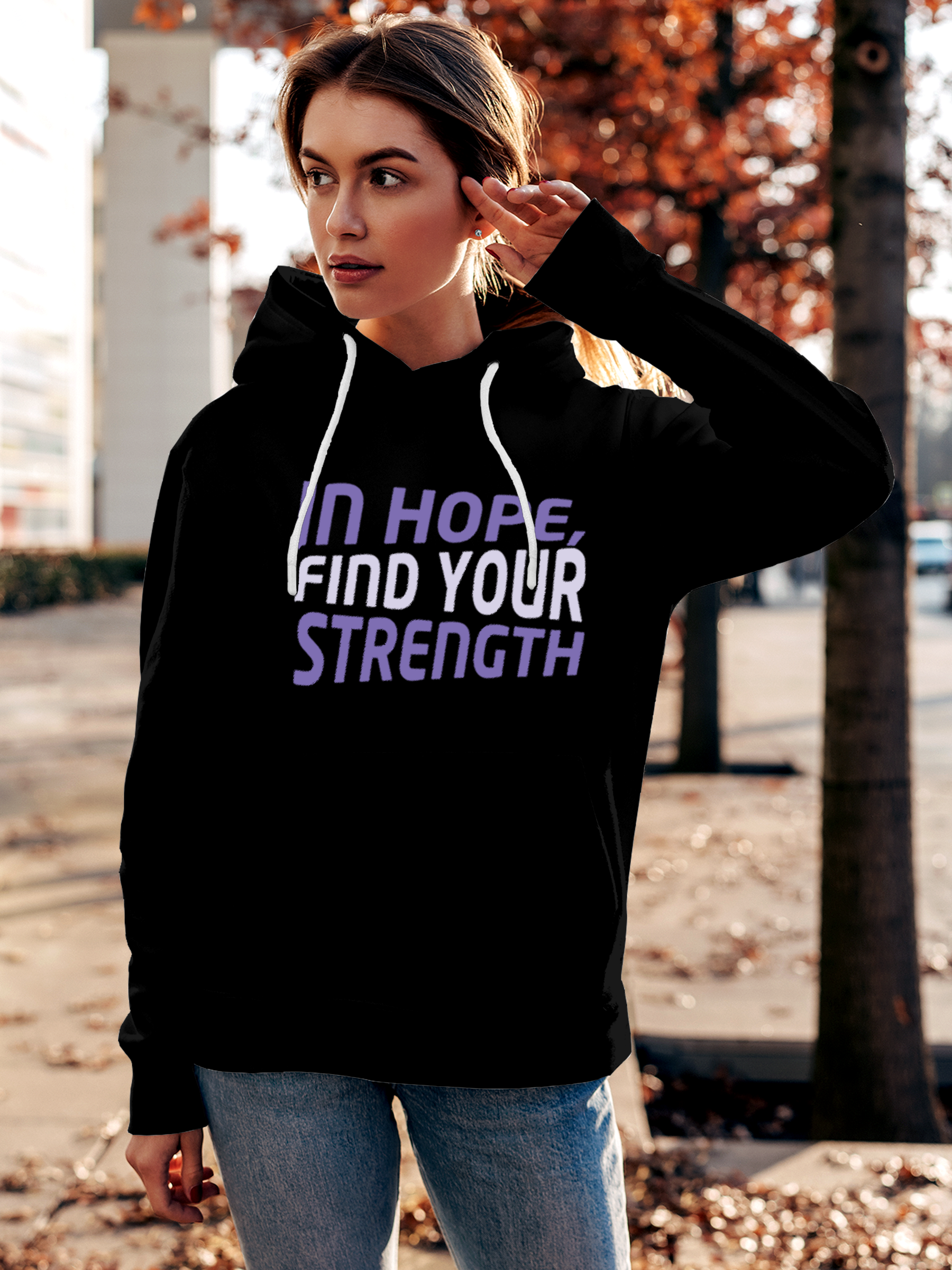 Model wearing Women's Black Hoodie Sweatshirt with 'In Hope, Find Your Strength' design, offering effortless style and premium comfort