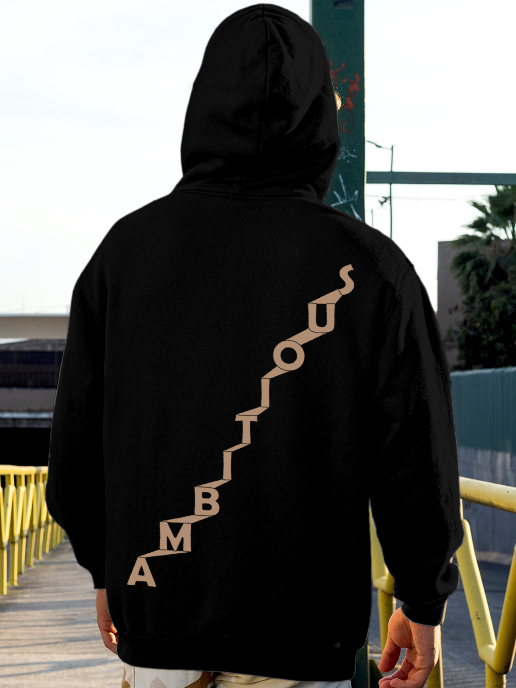 Model wearing Men's Black Hoodie Sweatshirt with 'Ambitious' design, offering effortless style and premium comfort