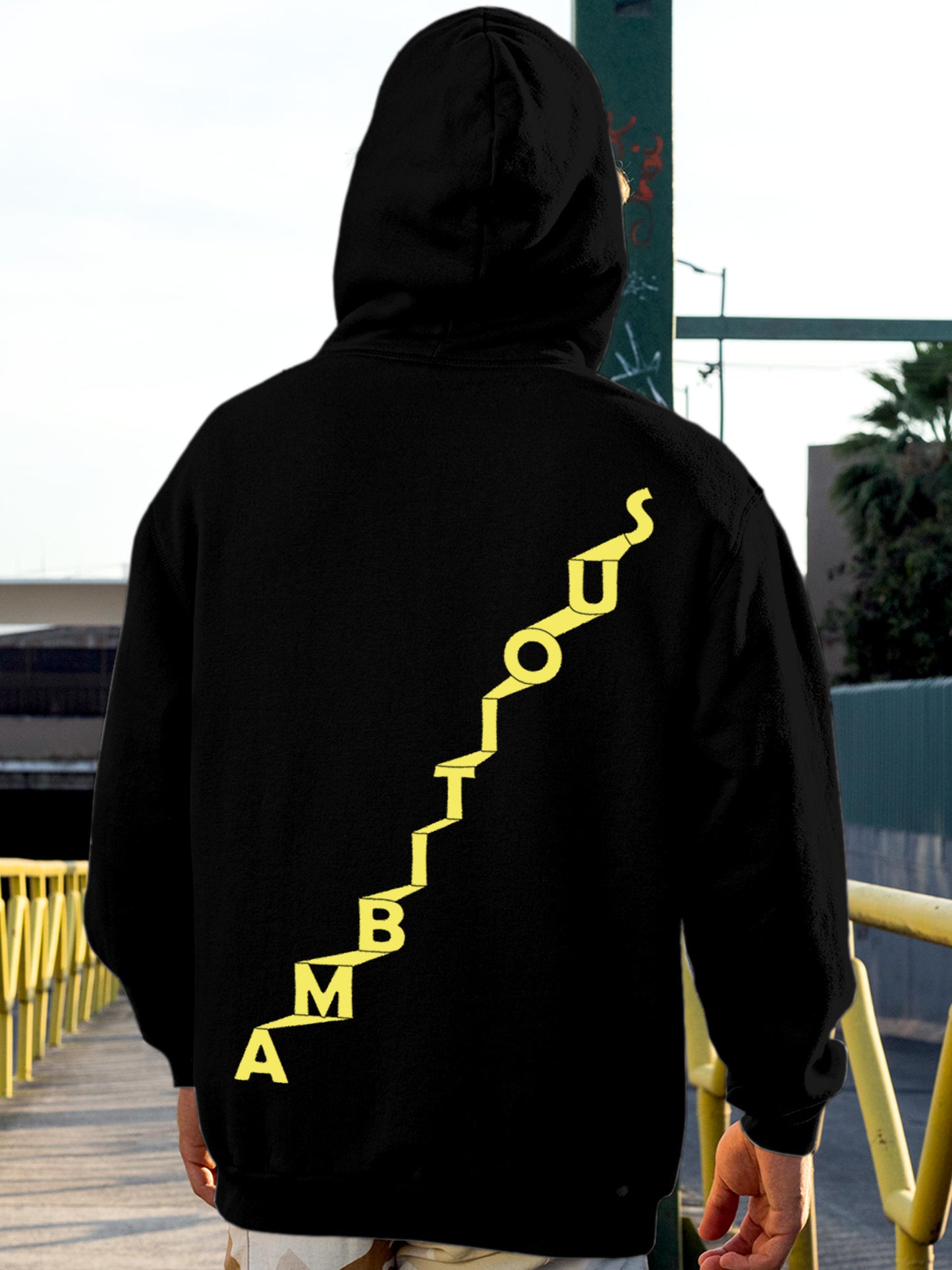 Model wearing Men's Black Hoodie Sweatshirt with 'Ambitious' design, offering effortless style and premium comfort