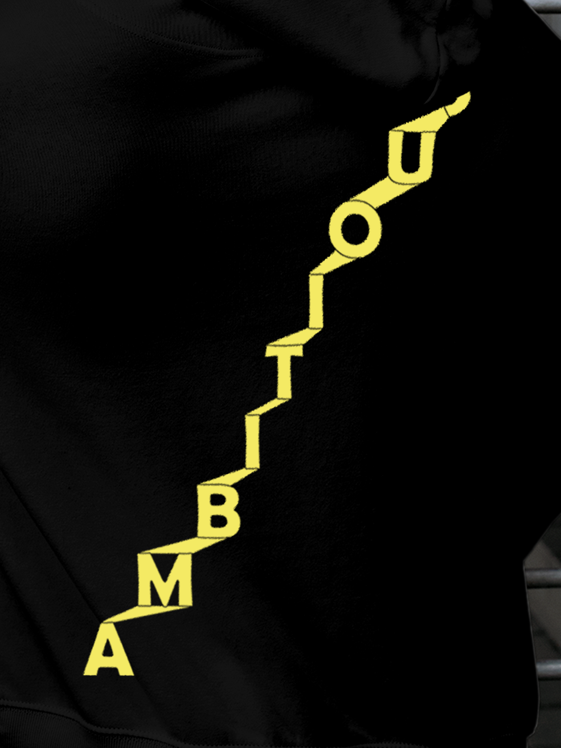 Close up of 'Ambitious' design on Men's Black Hoodie Sweatshirt, highlighting intricate details and vibrant print.