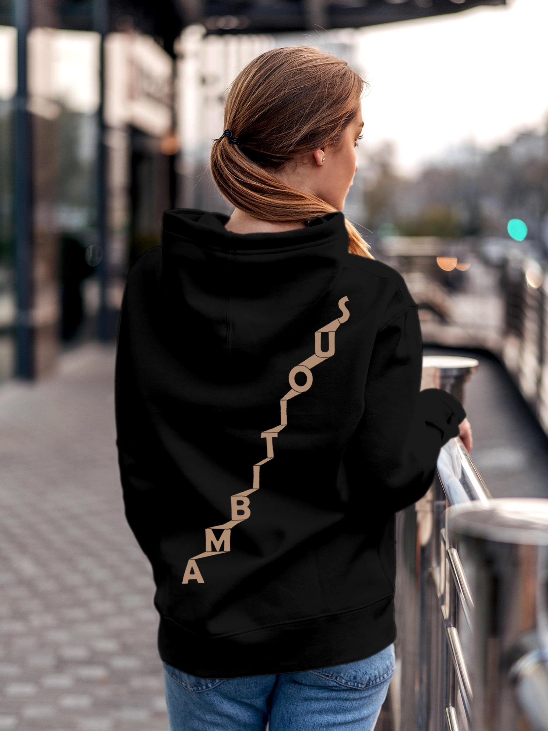 Model wearing Women's Black Hoodie Sweatshirt with 'Ambitious' design, offering effortless style and premium comfort