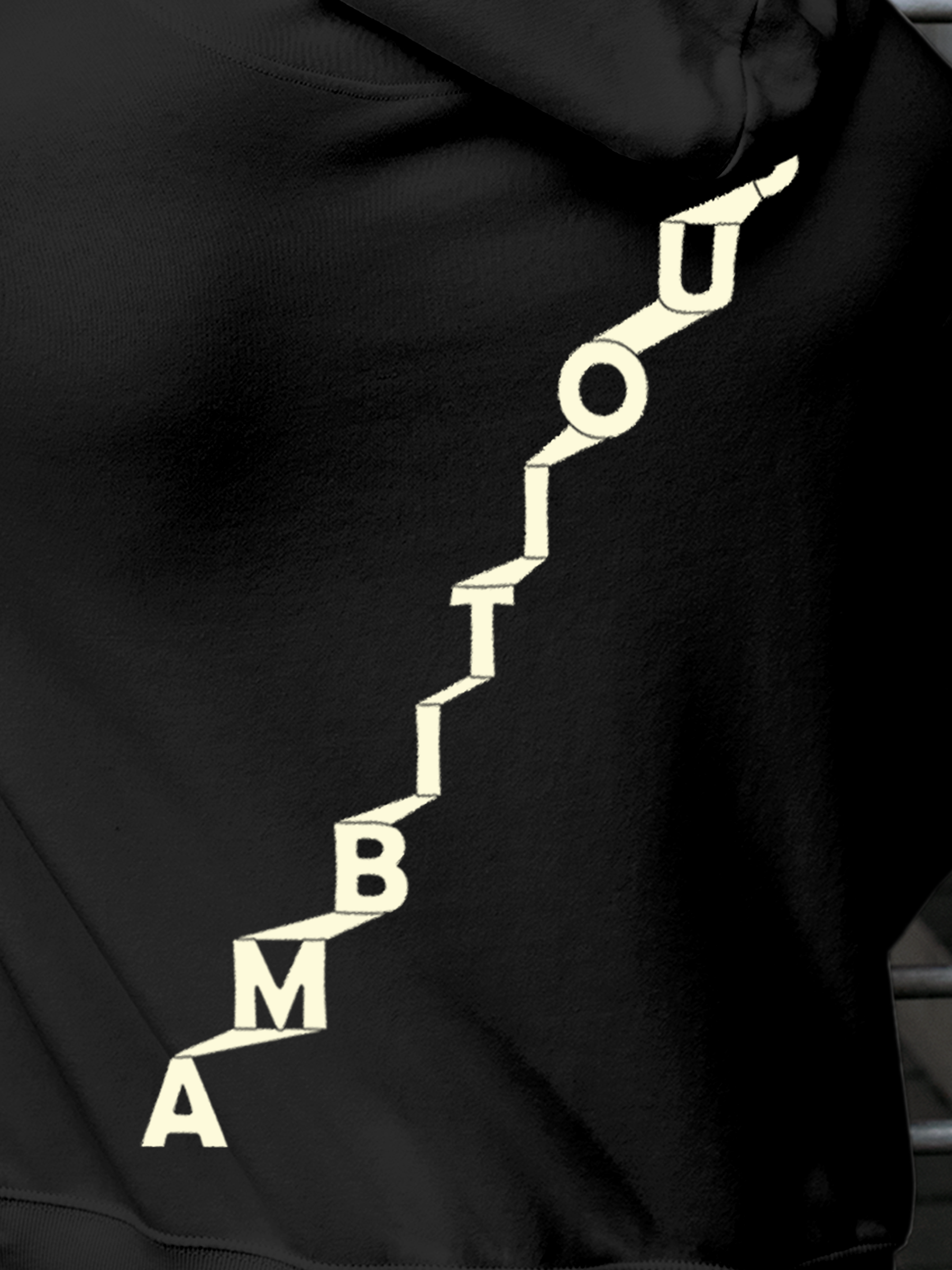 Close up of 'Ambitious' design on Men's Charcoal Grey Hoodie Sweatshirt, highlighting intricate details and vibrant print.
