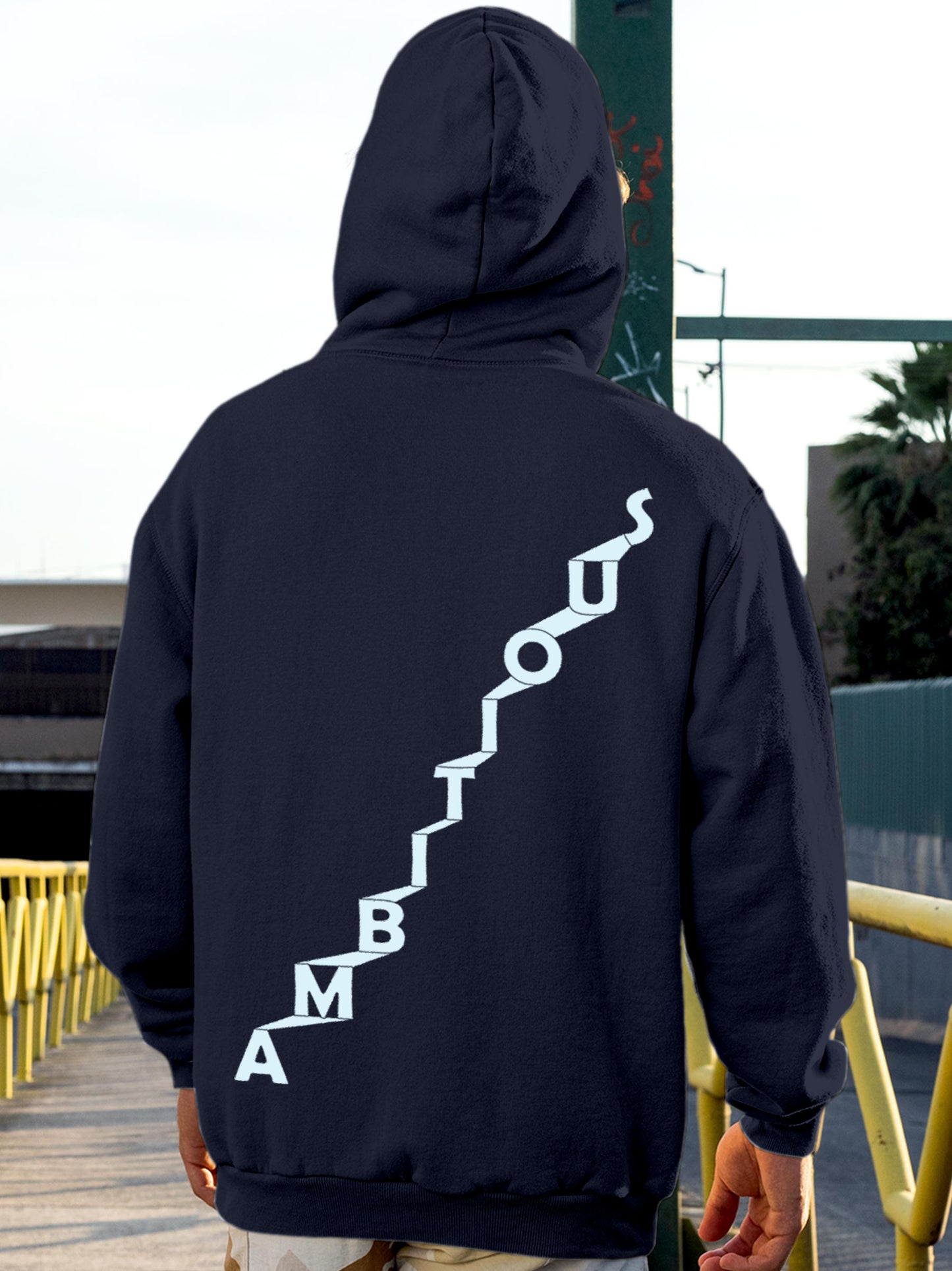 Model wearing Men's Navy Blue Hoodie Sweatshirt with 'Ambitious' design, offering effortless style and premium comfort