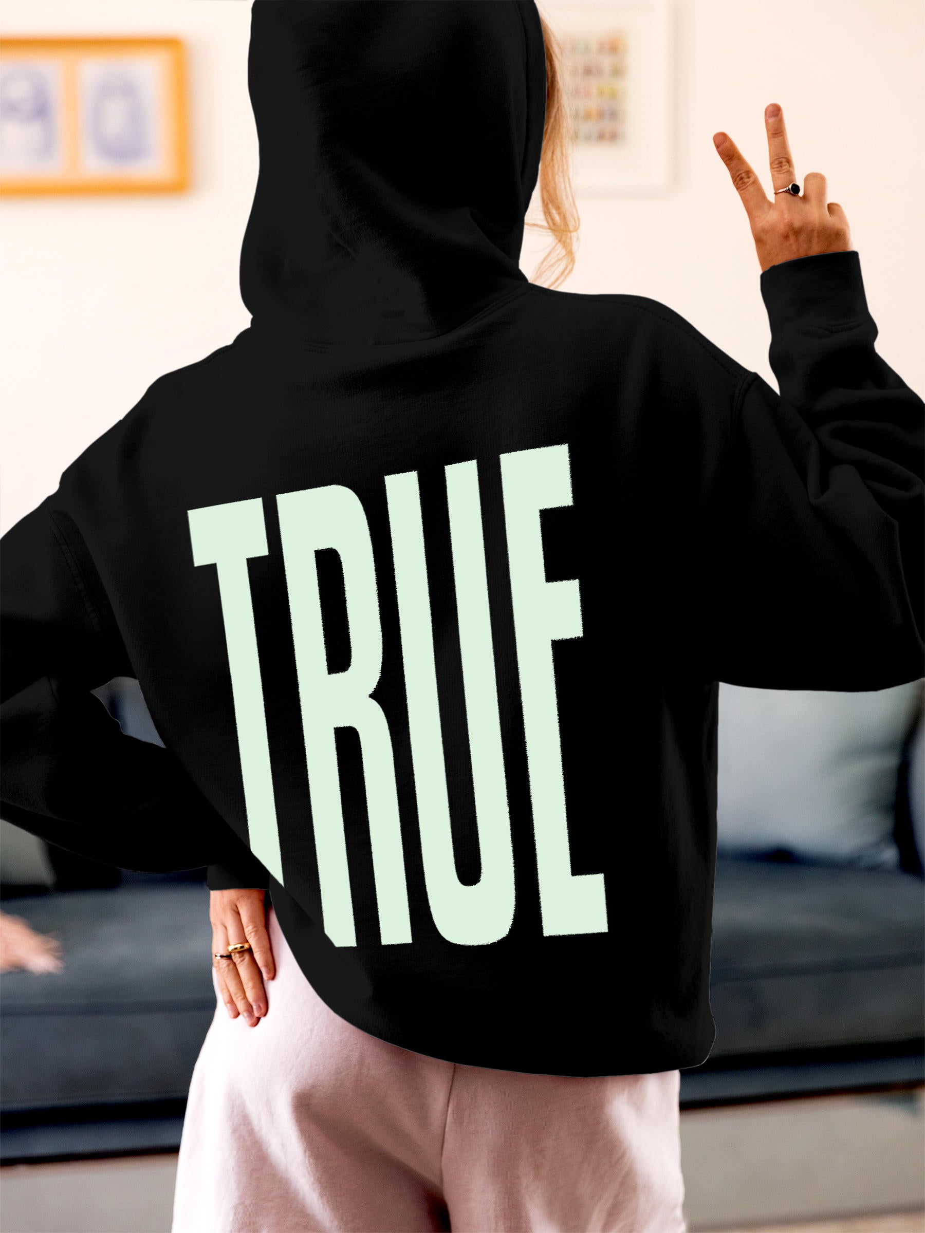 Model wearing Women's Black Hoodie Sweatshirt with 'Truth' design, offering effortless style and premium comfort