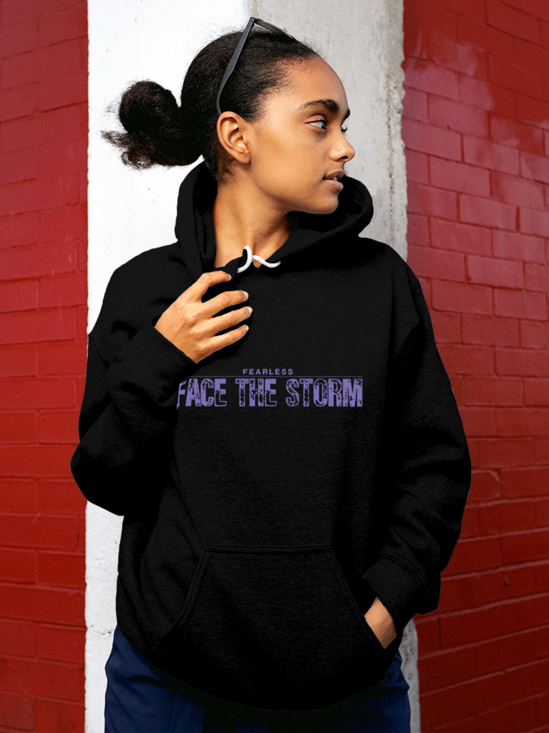 Model wearing Women's Black Hoodie Sweatshirt with 'Fearless. Face the Storm' design, offering effortless style and premium comfort