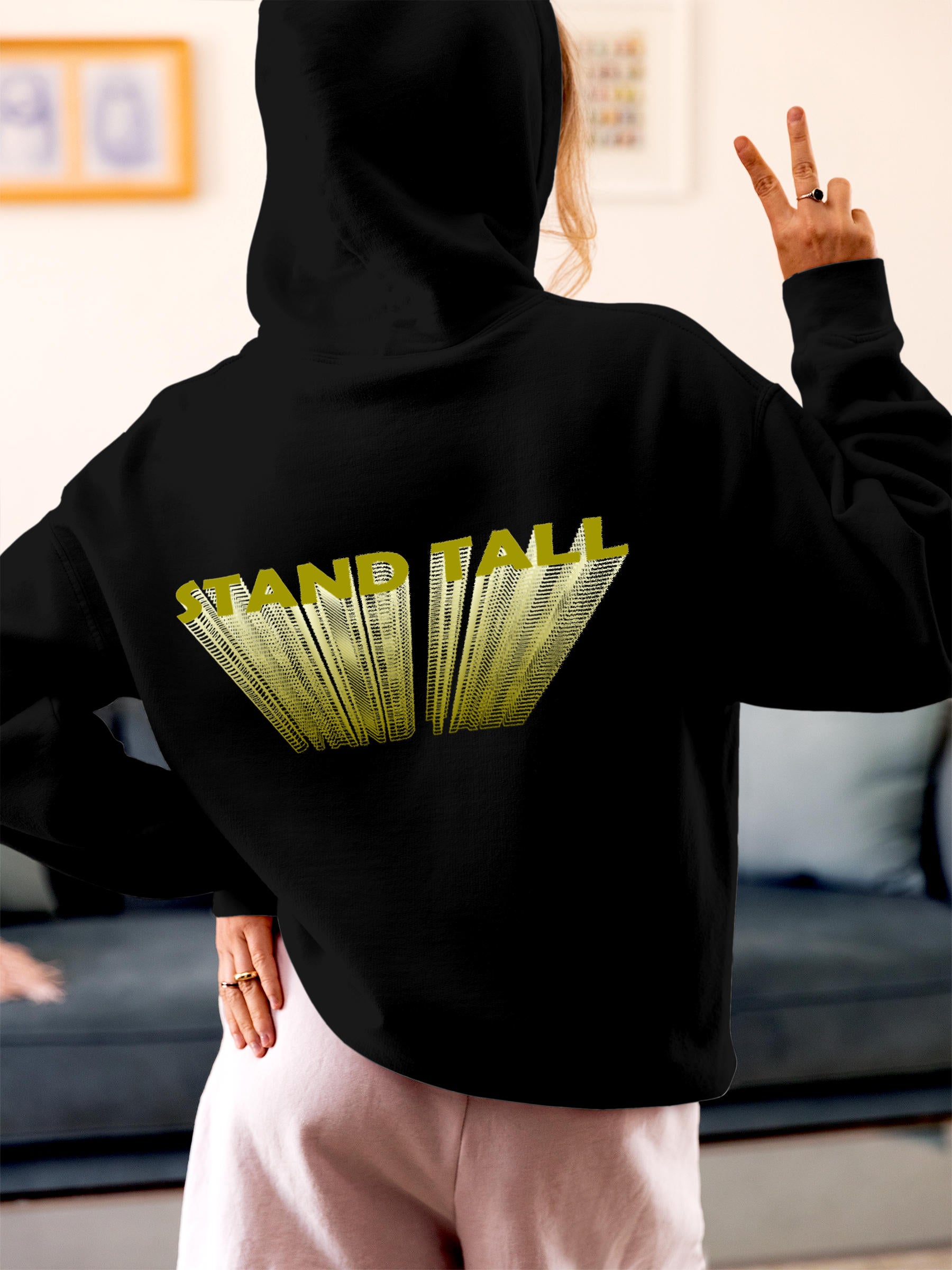 Model wearing Women's Black Hoodie Sweatshirt with 'Stand Tall' design, offering effortless style and premium comfort