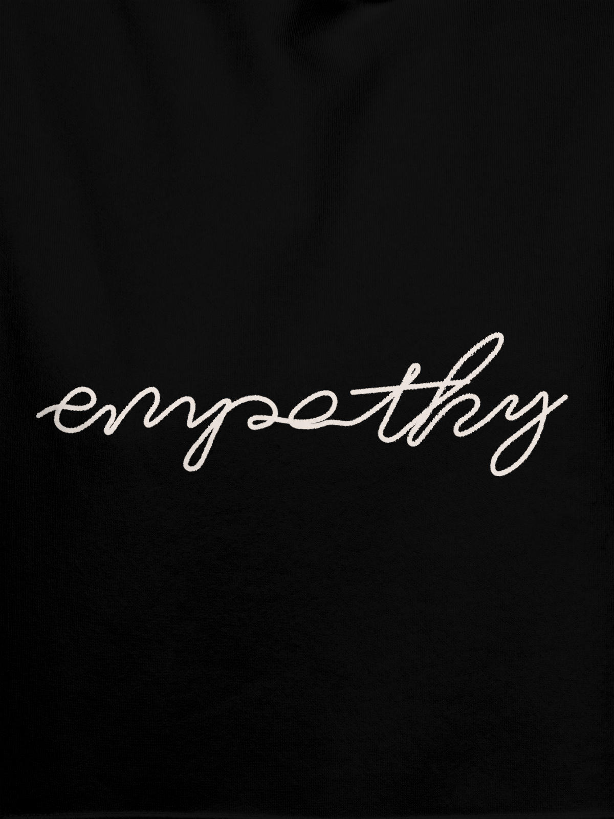 Close up of 'Empathy' design on Women's Black Hoodie Sweatshirt, highlighting intricate details and vibrant print.