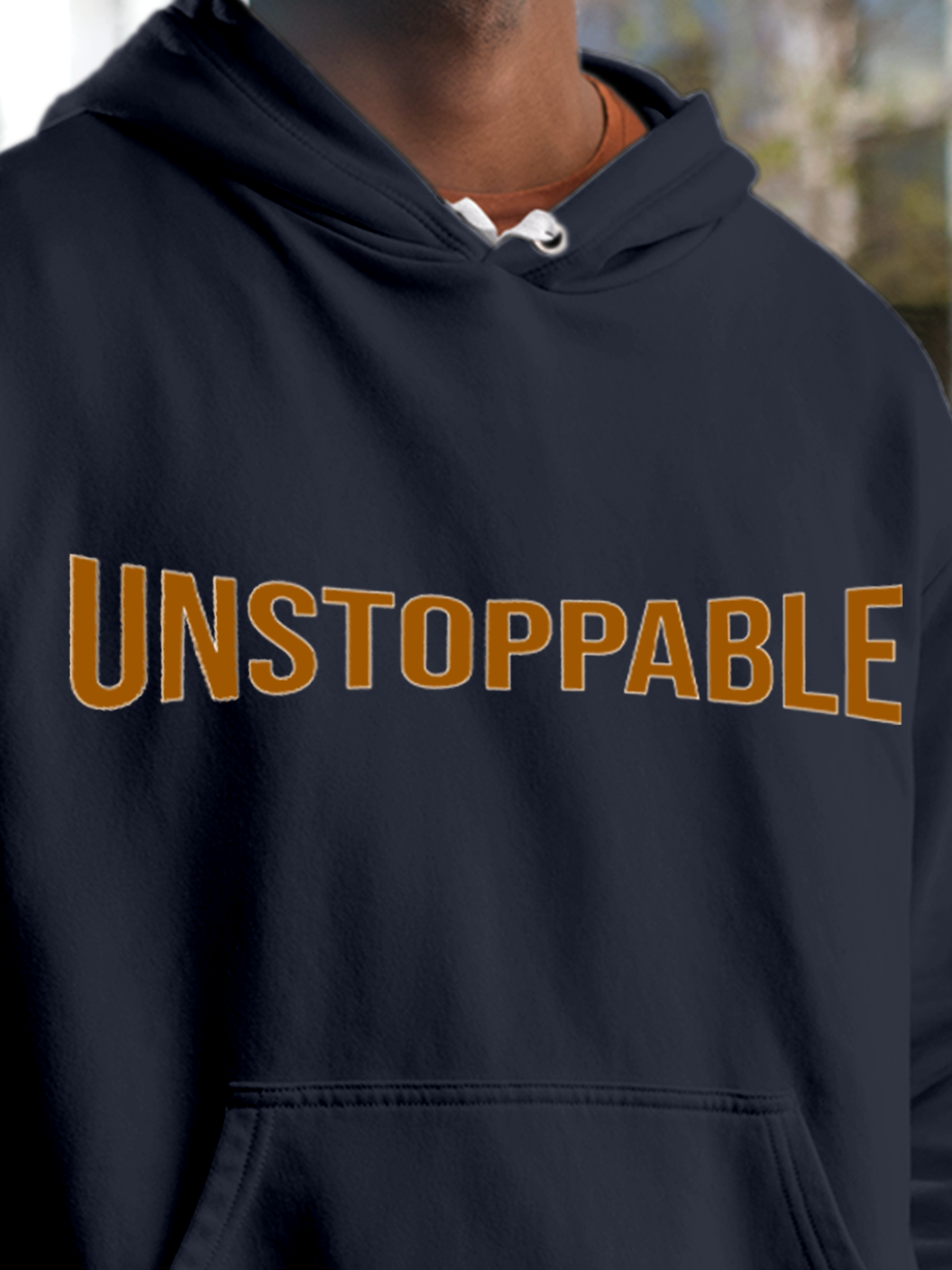 Close up of 'Unstoppable' design on Men's Navy Blue Hoodie Sweatshirt, highlighting intricate details and vibrant print.