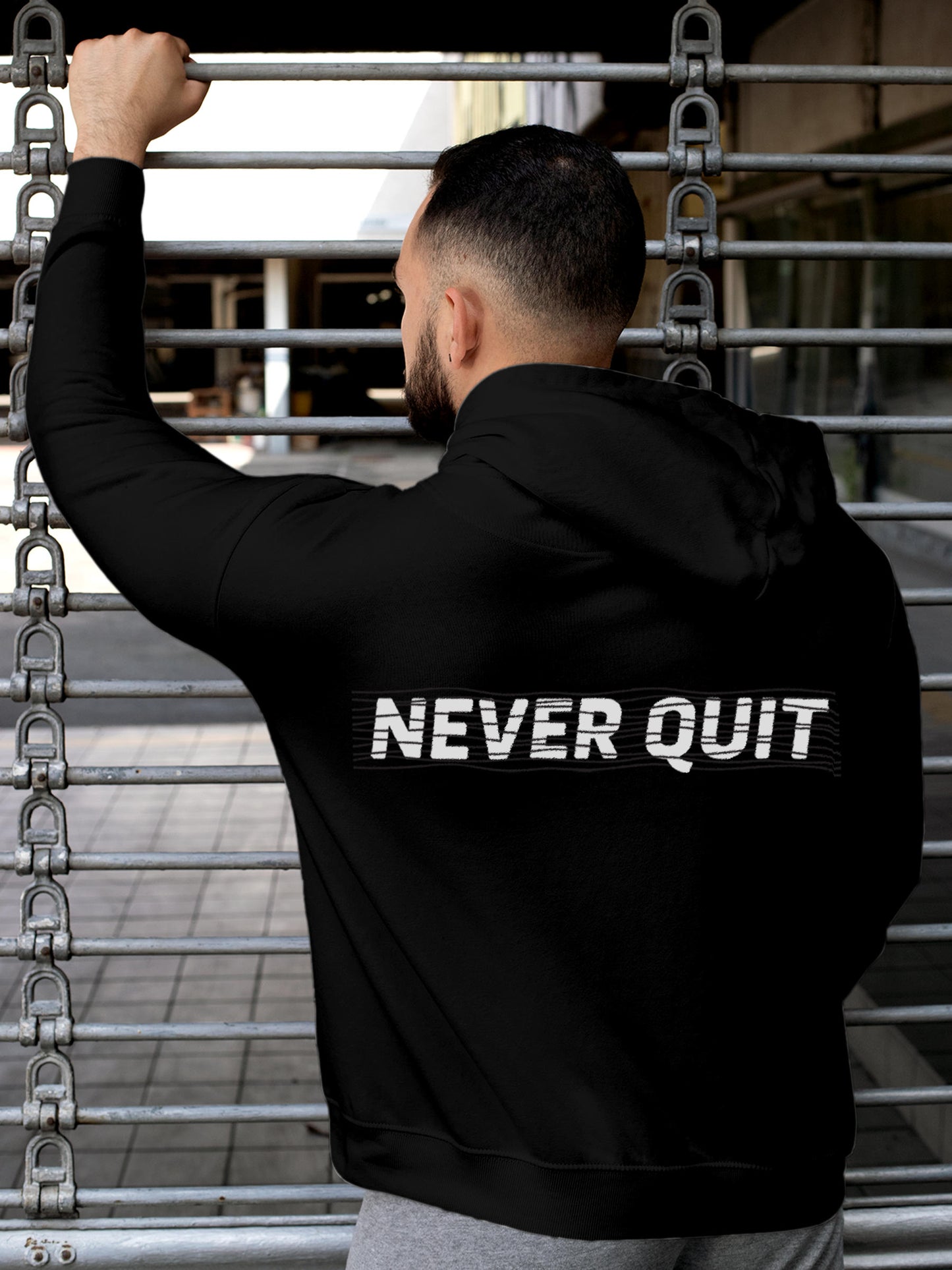 Model wearing Men's Black Hoodie Sweatshirt with 'Never Quit' design, offering effortless style and premium comfort