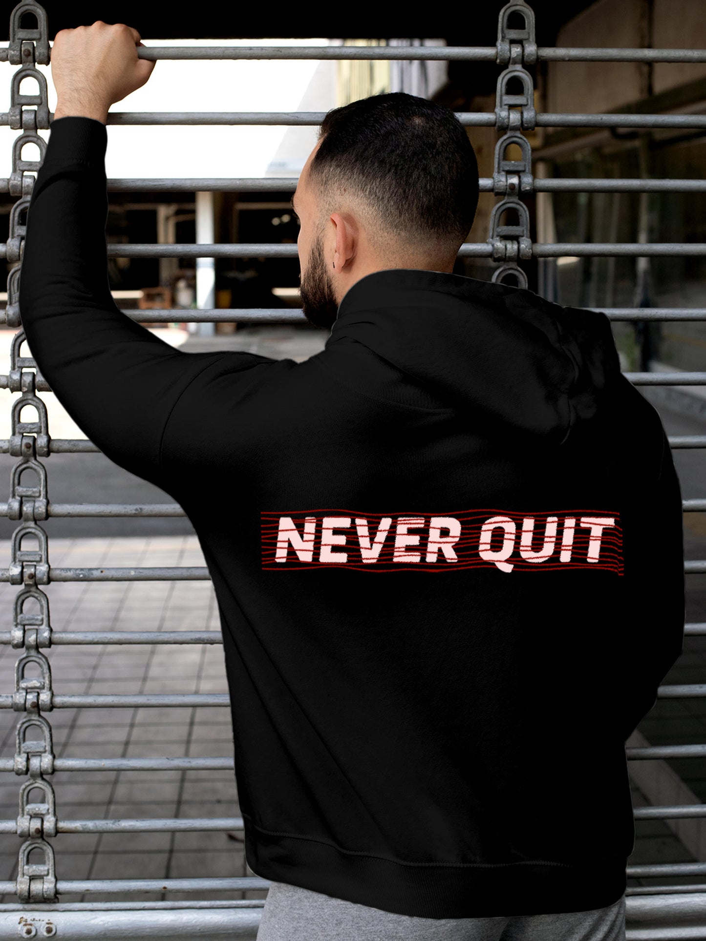 Model wearing Men's Black Hoodie Sweatshirt with 'Never Quit' design, offering effortless style and premium comfort