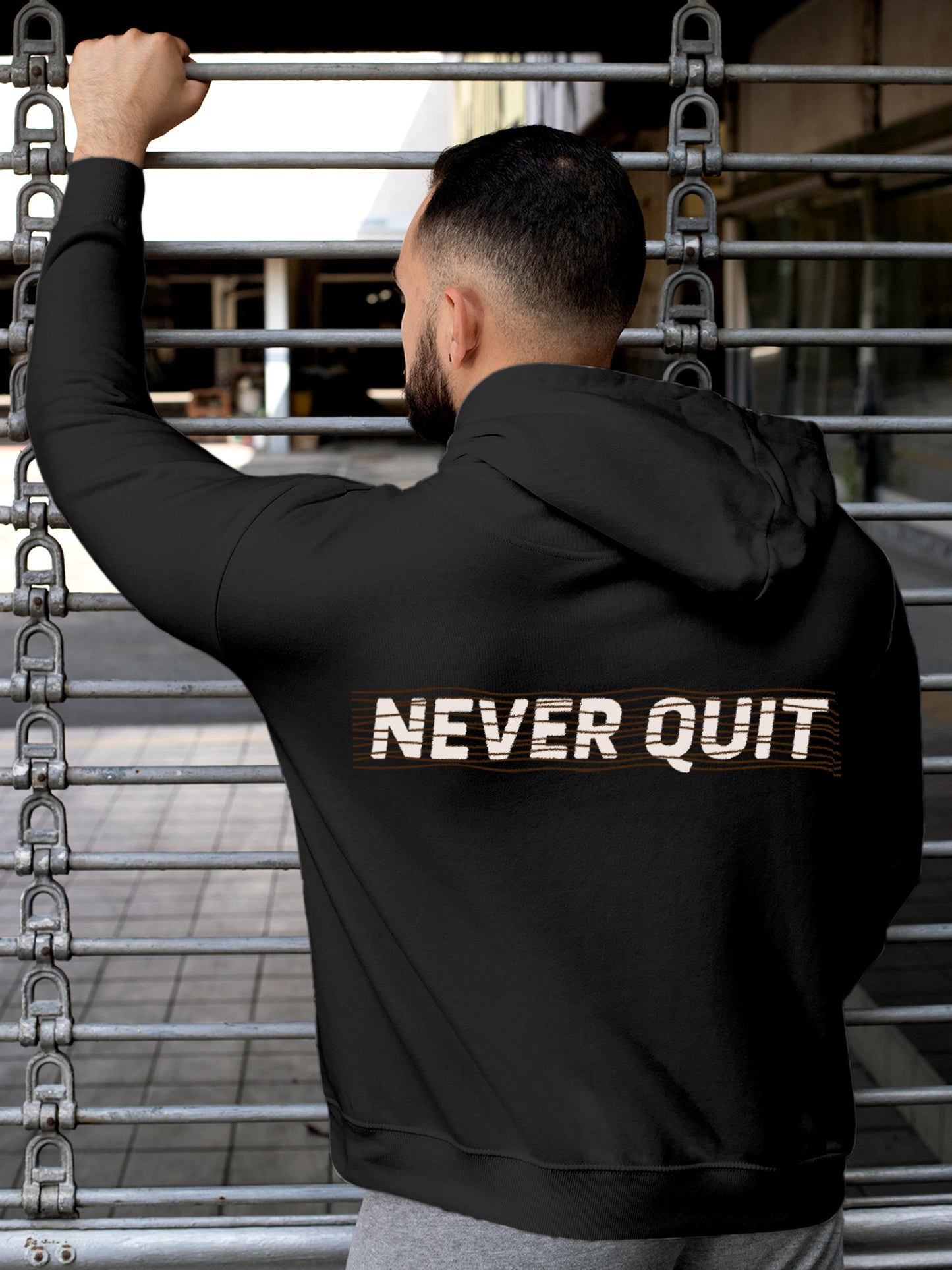 Model wearing Men's Dark Grey Hoodie Sweatshirt with 'Never Quit' design, offering effortless style and premium comfort
