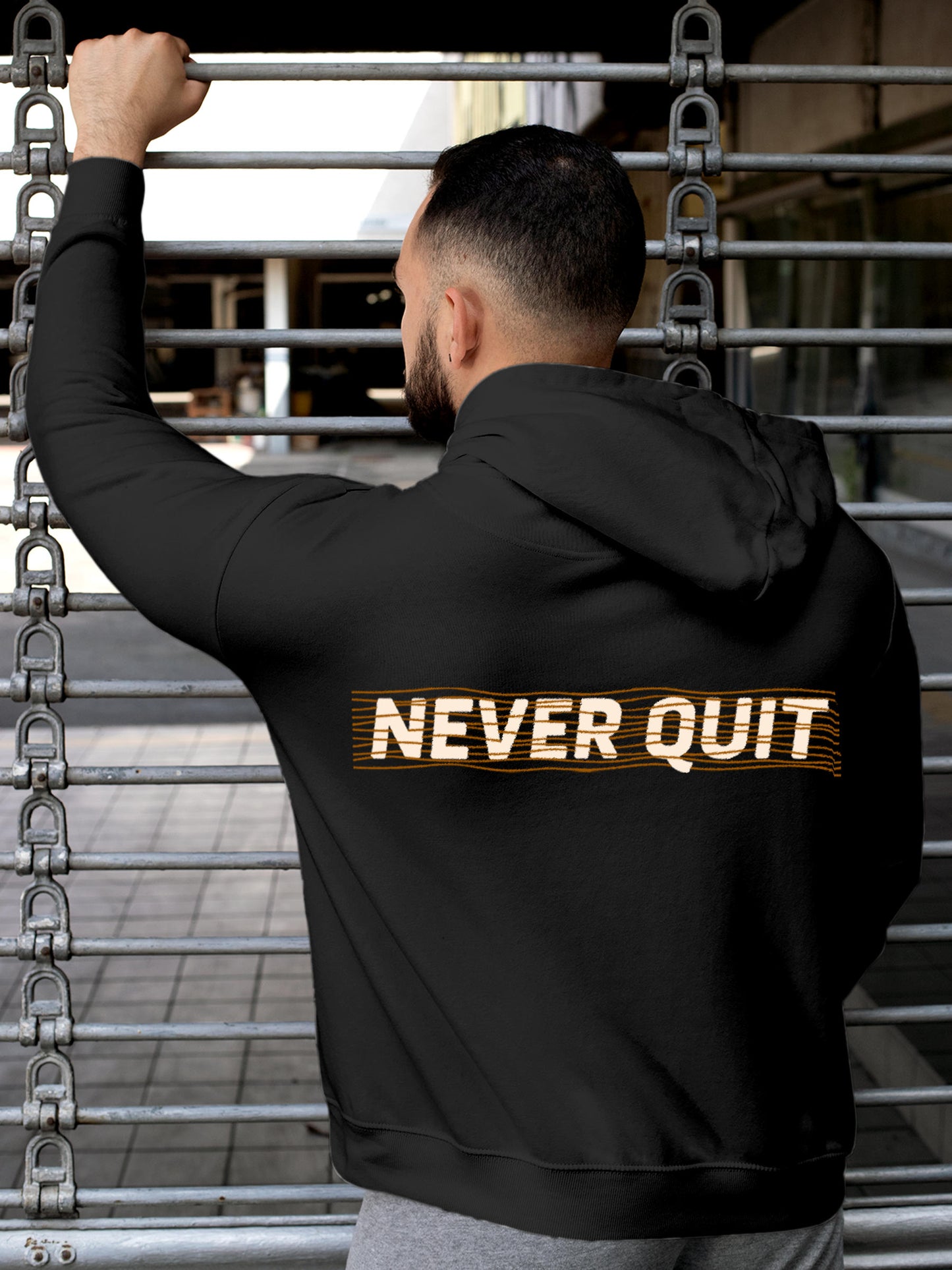 Model wearing Men's Dark Grey Hoodie Sweatshirt with 'Never Quit' design, offering effortless style and premium comfort