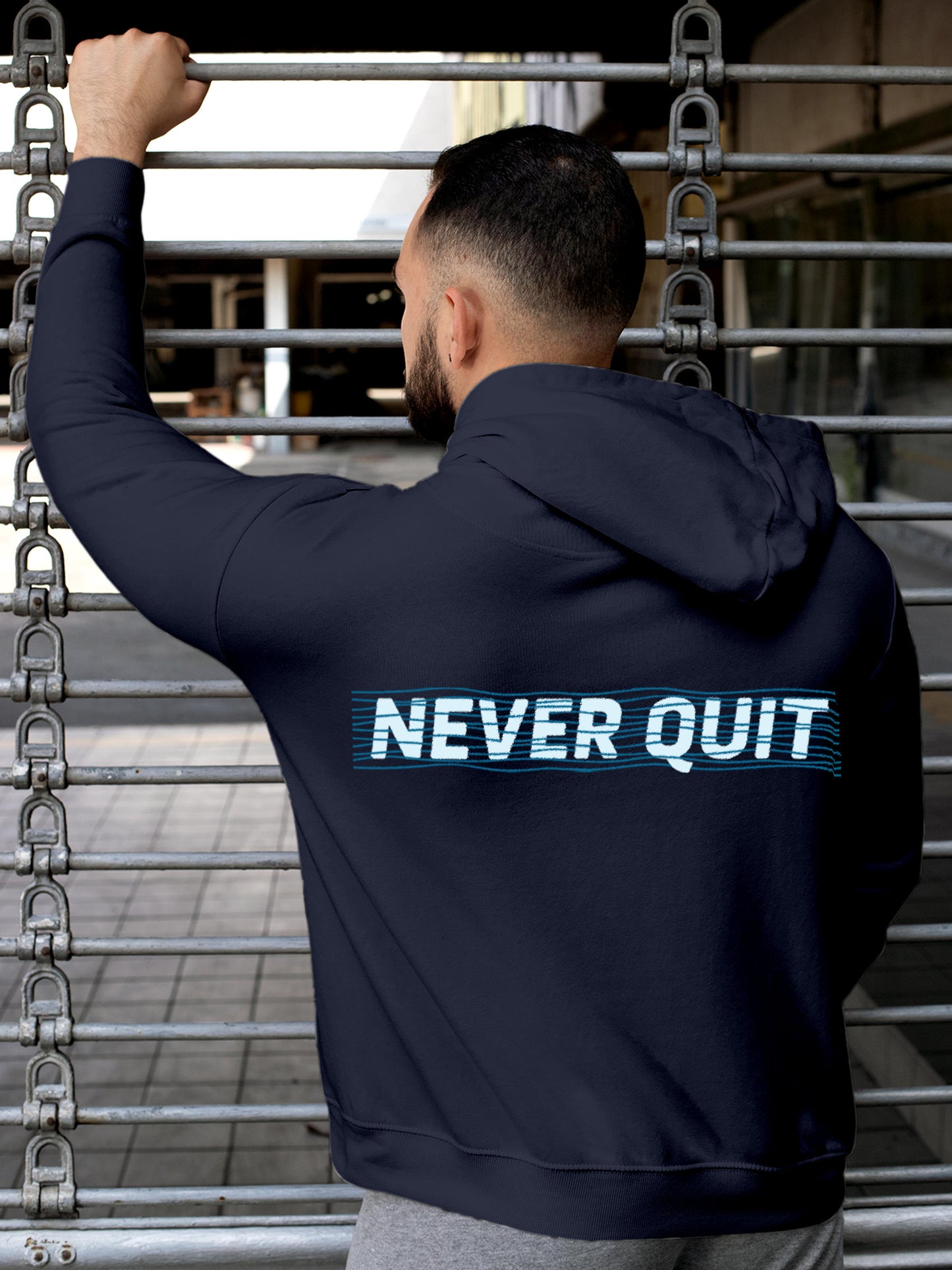 Model wearing Men's Navy Blue Hoodie Sweatshirt with 'Never Quit' design, offering effortless style and premium comfort