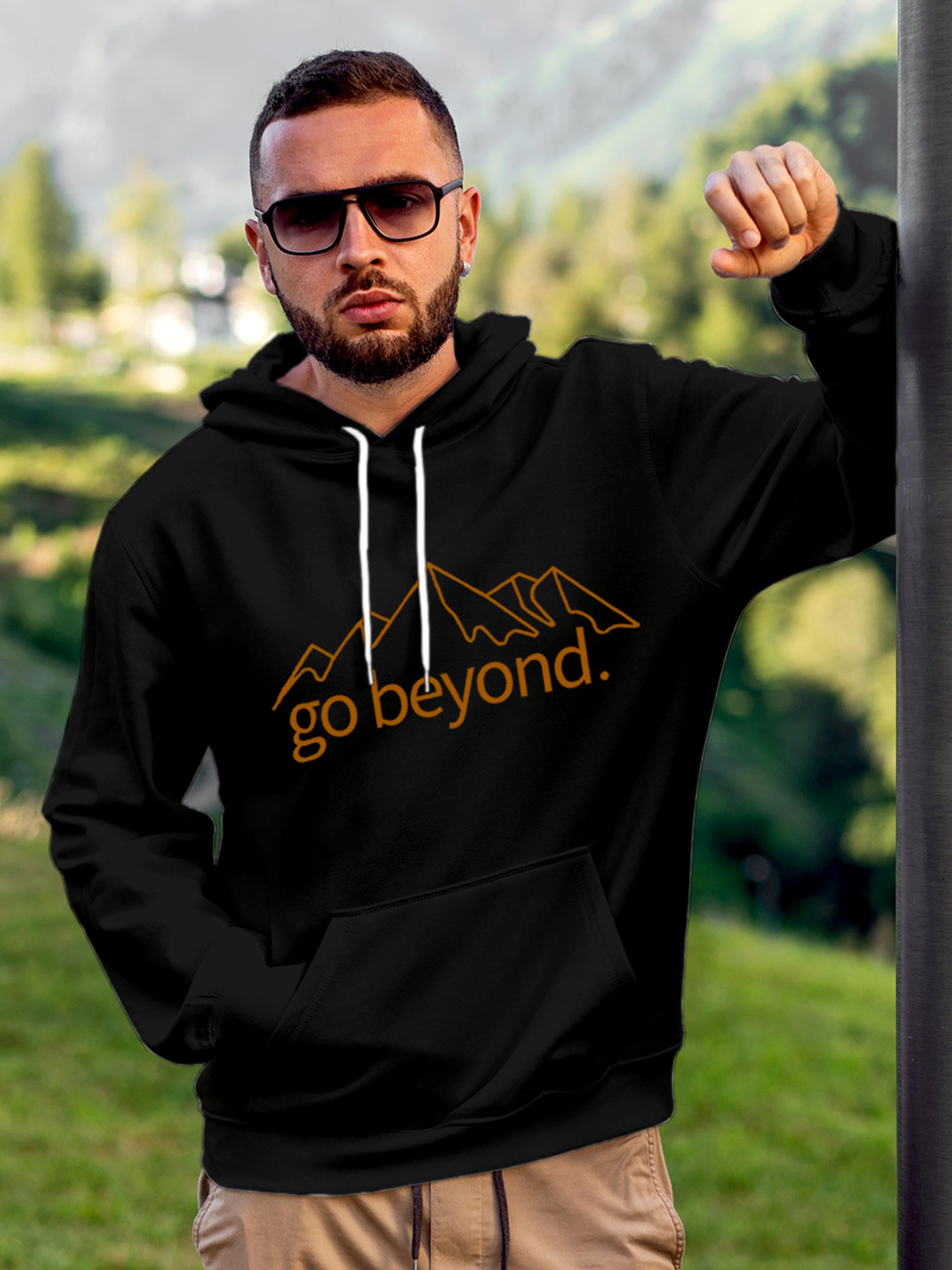 Model wearing Men's Black Hoodie Sweatshirt with 'Go Beyond' design, offering effortless style and premium comfort
