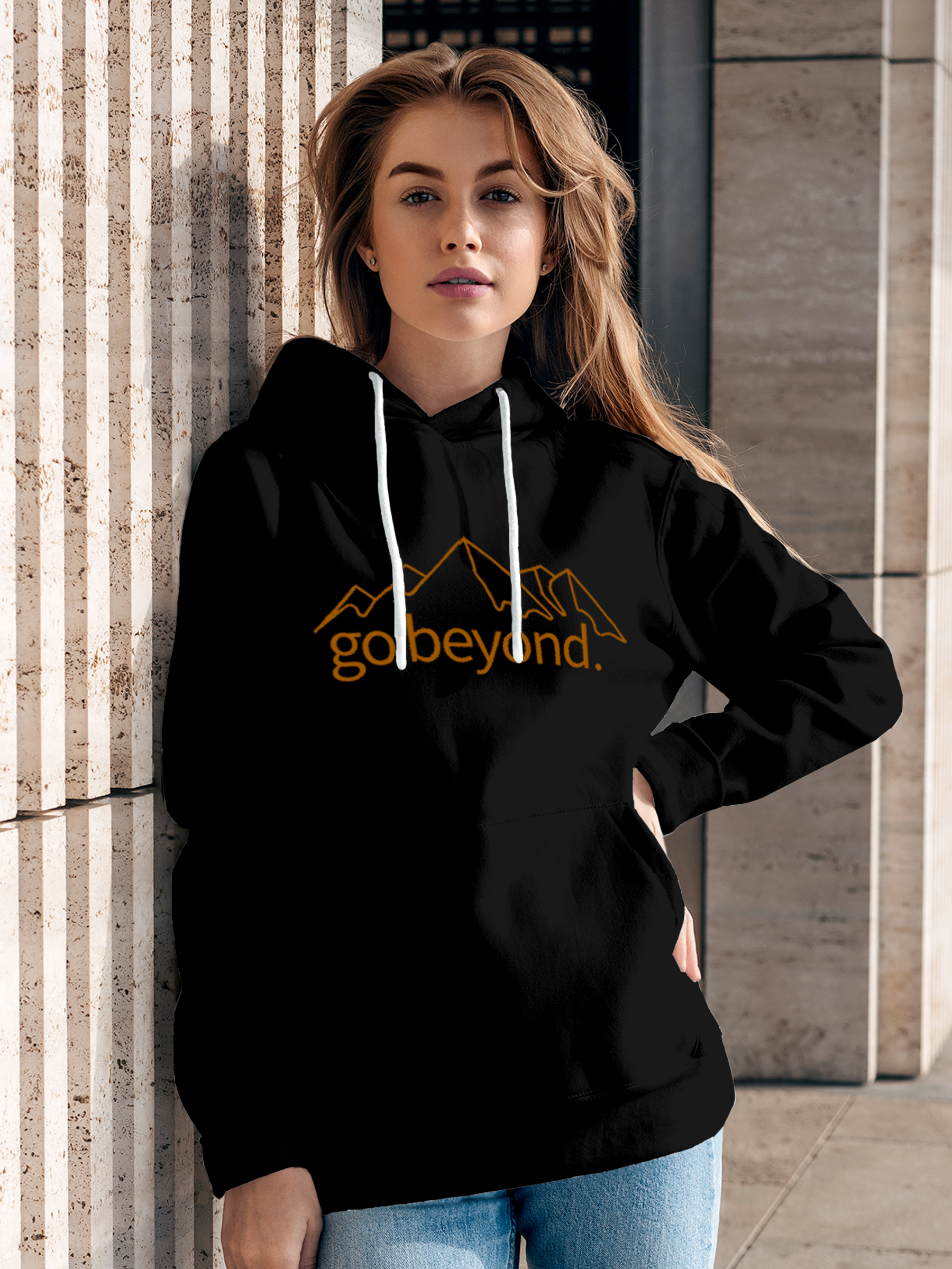 Model wearing Women's Black Hoodie Sweatshirt with 'Go Beyond' design, offering effortless style and premium comfort