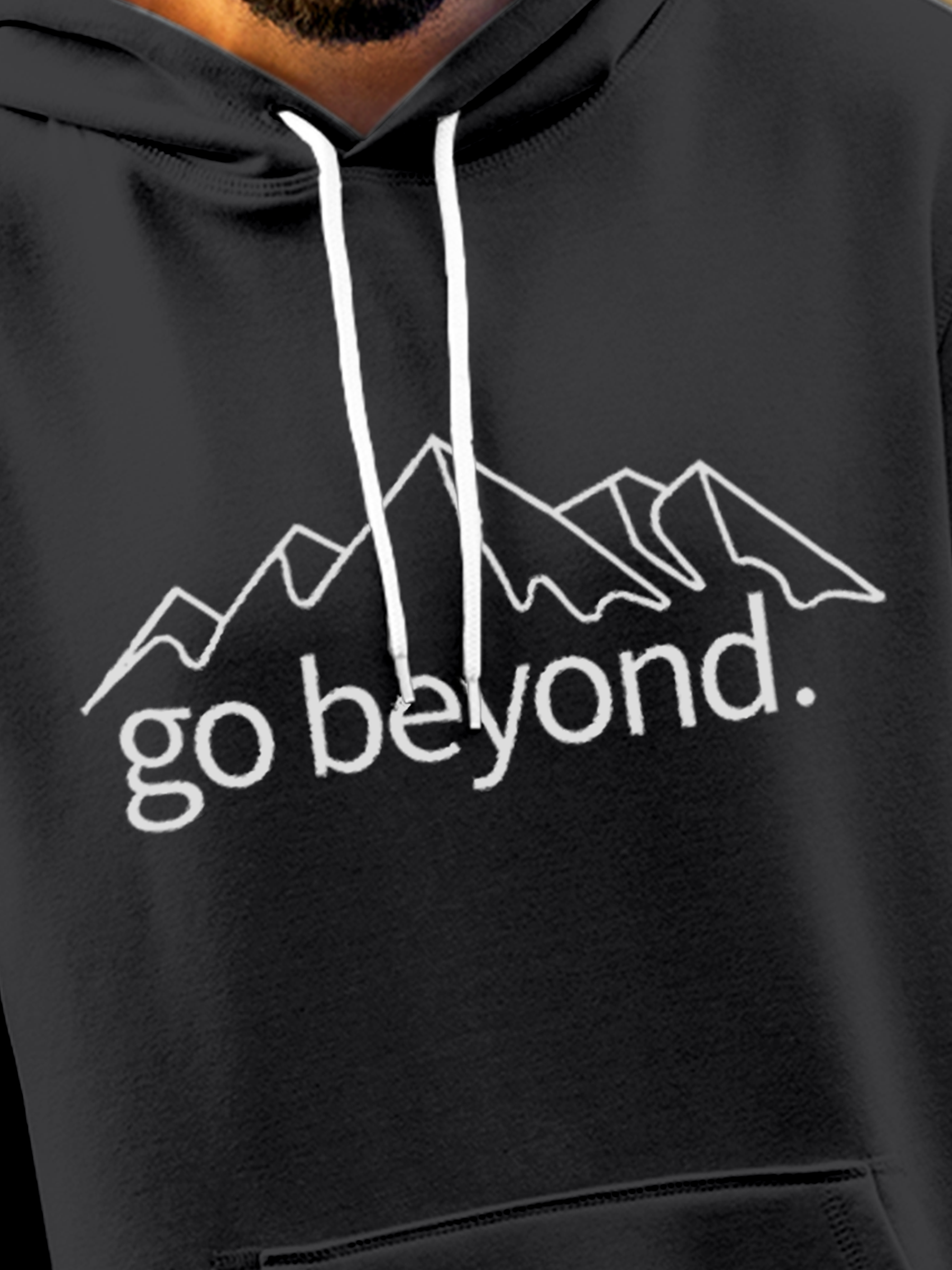 Close up of 'Go Beyond' design on Men's Charcoal Grey Hoodie Sweatshirt, highlighting intricate details and vibrant print.