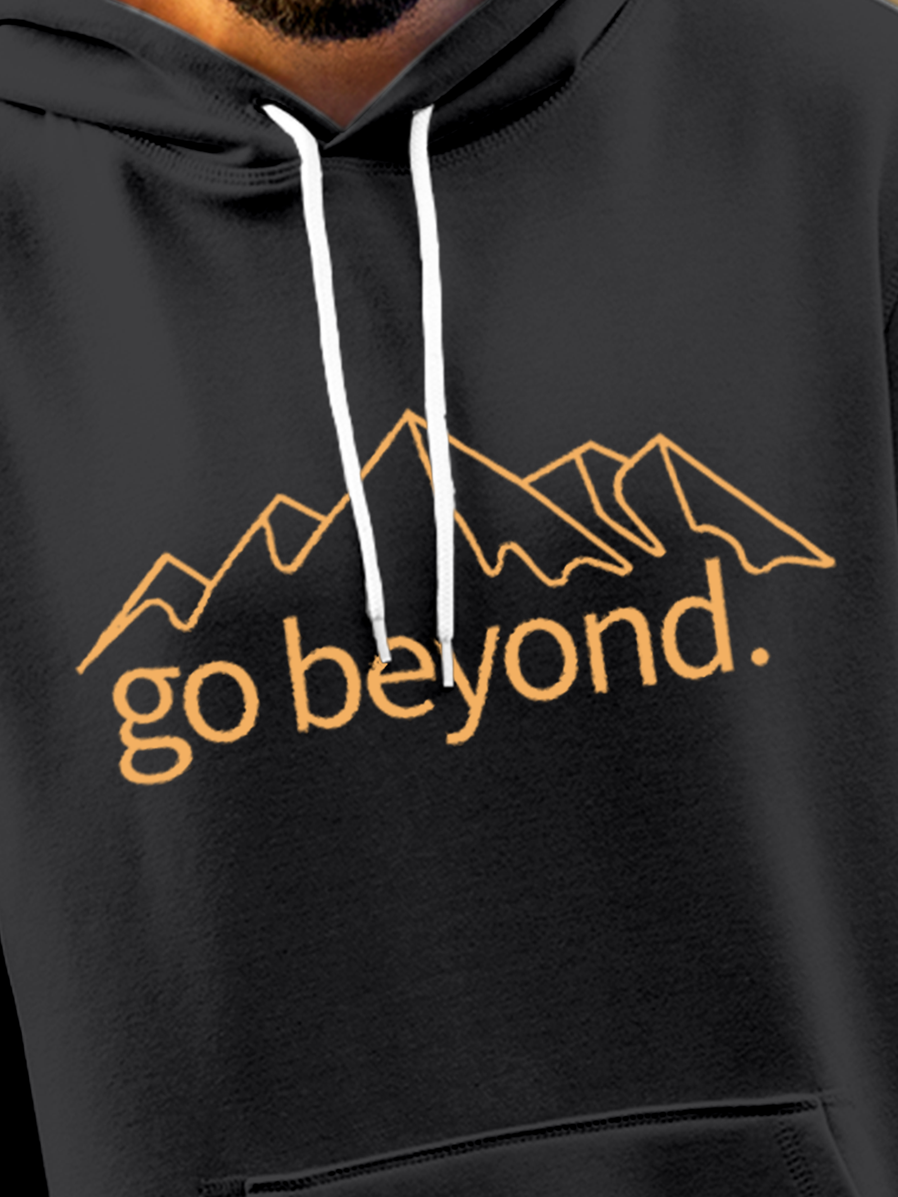 Close up of 'Go Beyond' design on Men's Charcoal Grey Hoodie Sweatshirt, highlighting intricate details and vibrant print.