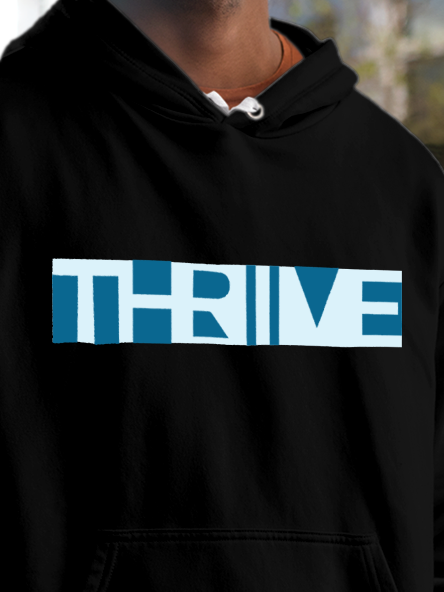Close up of 'Thrive' design on Men's Black Hoodie Sweatshirt, highlighting intricate details and vibrant print.