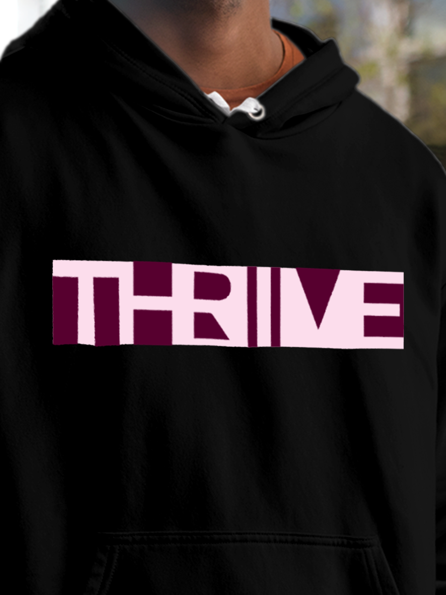 Close up of 'Thrive' design on Men's Black Hoodie Sweatshirt, highlighting intricate details and vibrant print.