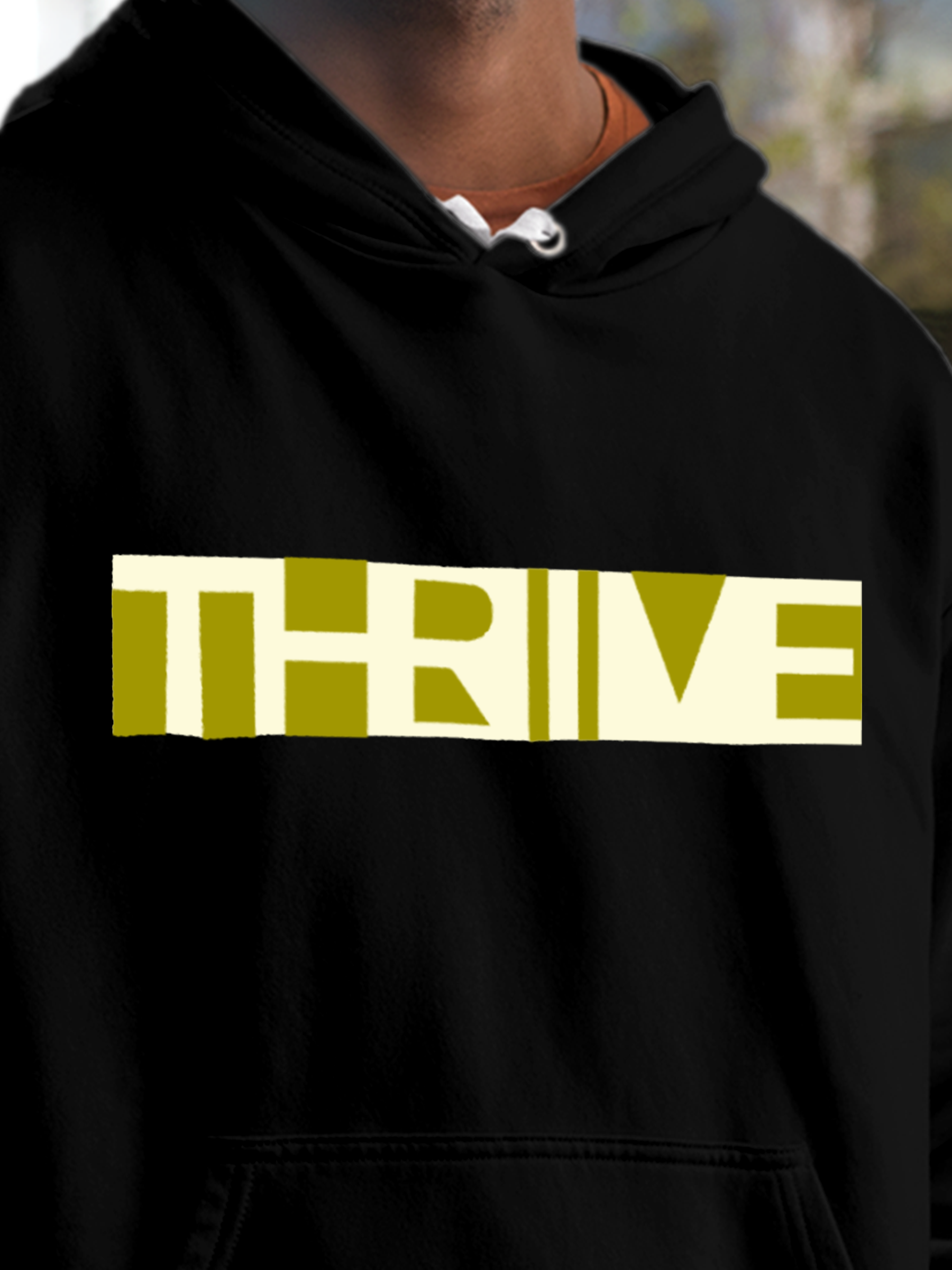 Close up of 'Thrive' design on Men's Black Hoodie Sweatshirt, highlighting intricate details and vibrant print.