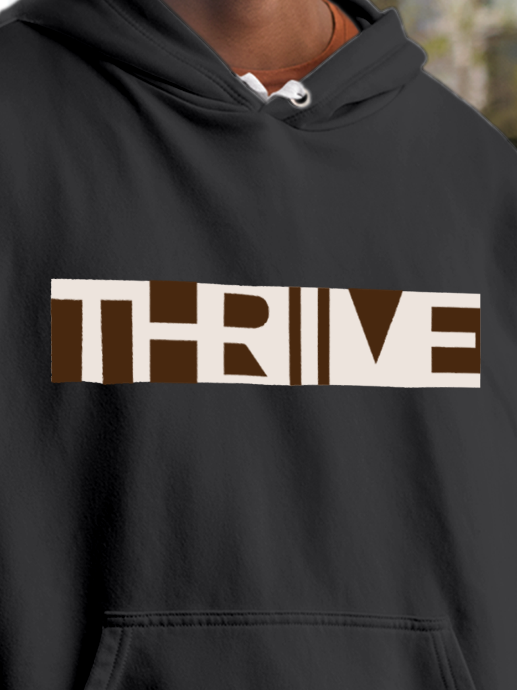 Close up of 'Thrive' design on Men's Charcoal Grey Hoodie Sweatshirt, highlighting intricate details and vibrant print.