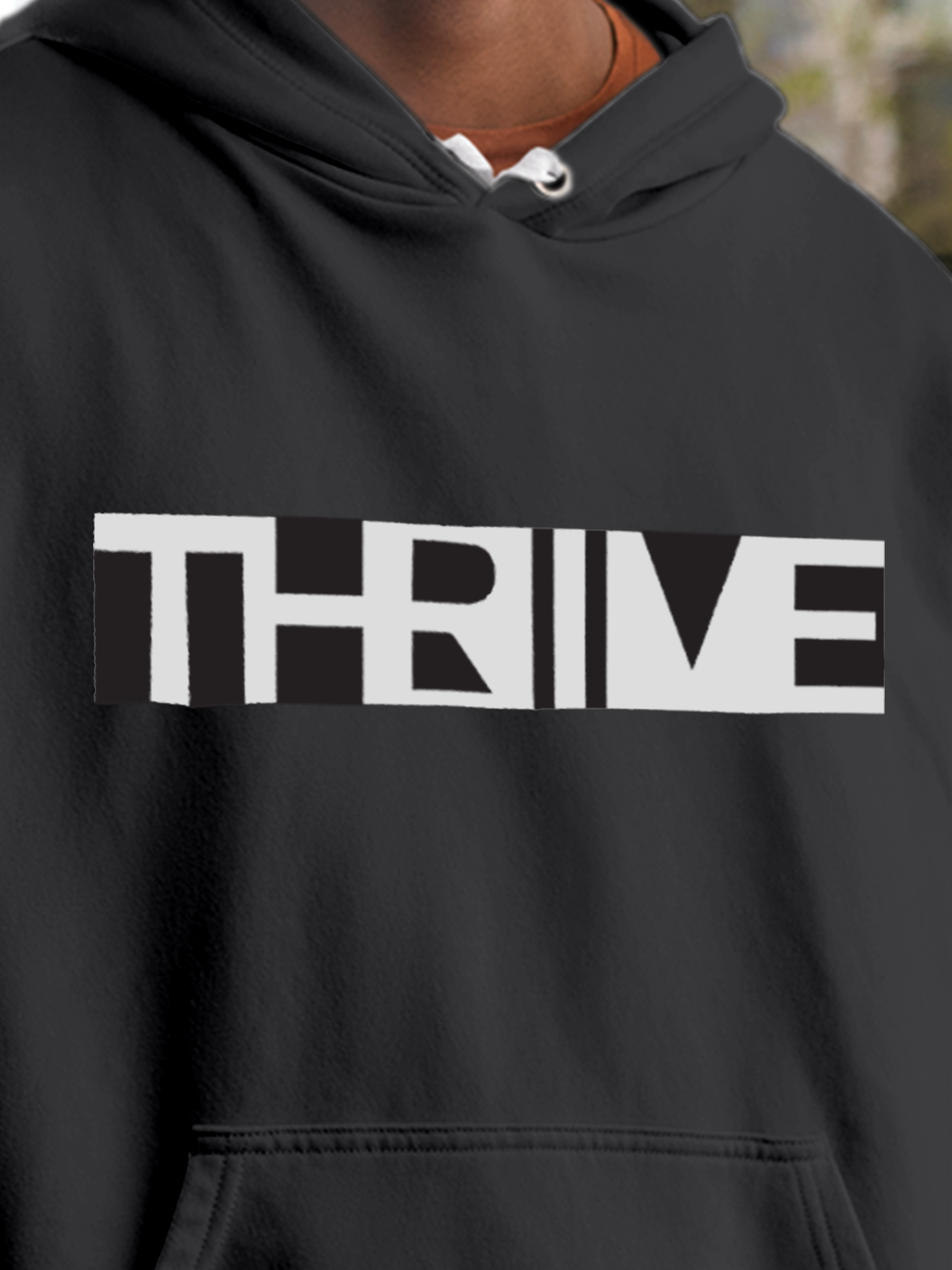 Close up of 'Thrive' design on Men's Charcoal Grey Hoodie Sweatshirt, highlighting intricate details and vibrant print.