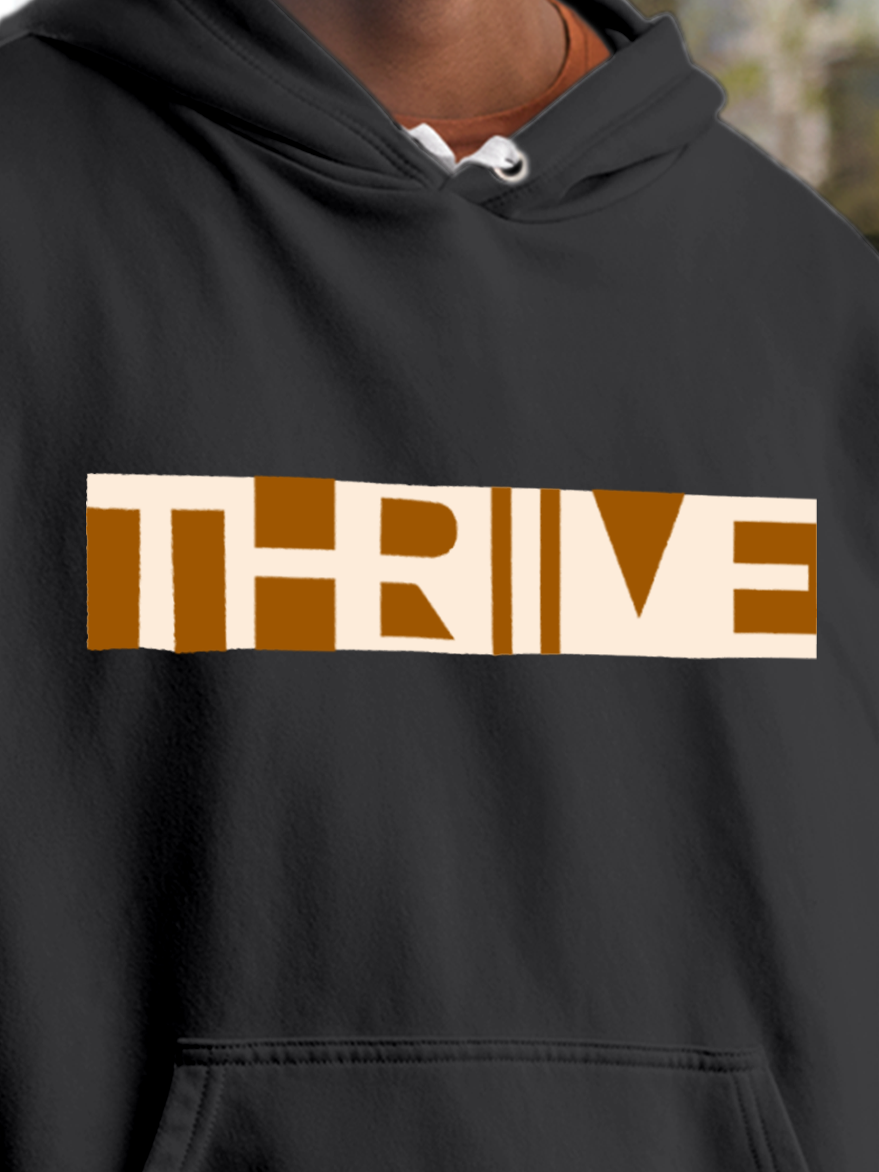 Close up of 'Thrive' design on Men's Charcoal Grey Hoodie Sweatshirt, highlighting intricate details and vibrant print.