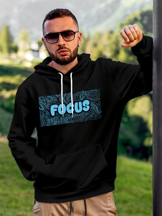 Model wearing Men's Black Hoodie Sweatshirt with 'Focus In Chaos' design, offering effortless style and premium comfort