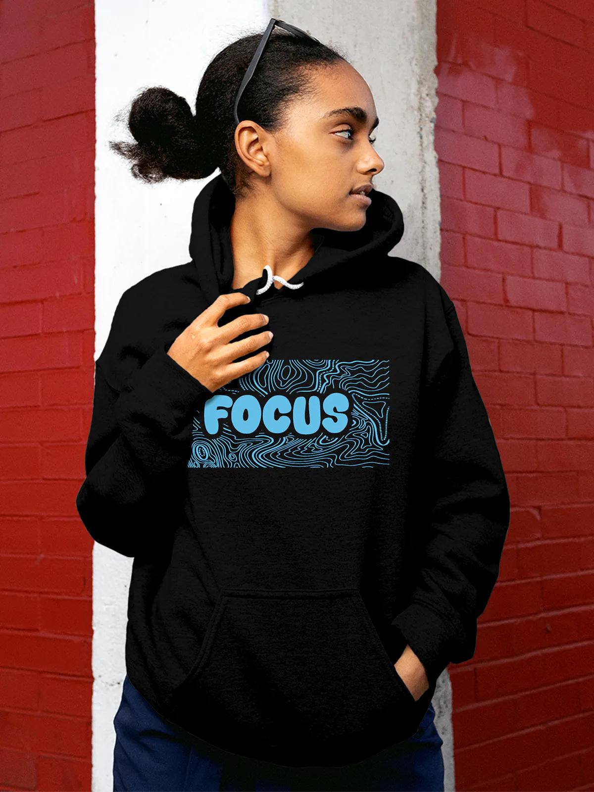 Model wearing Women's Black Hoodie Sweatshirt with 'Focus In Chaos' design, offering effortless style and premium comfort
