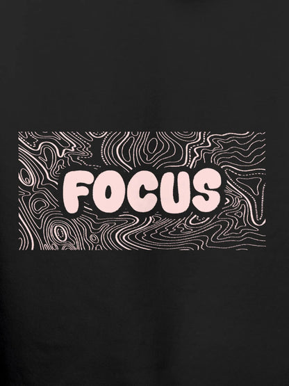 Close up of 'Focus In Chaos' design on Women's Dark Grey Hoodie Sweatshirt, highlighting intricate details and vibrant print.
