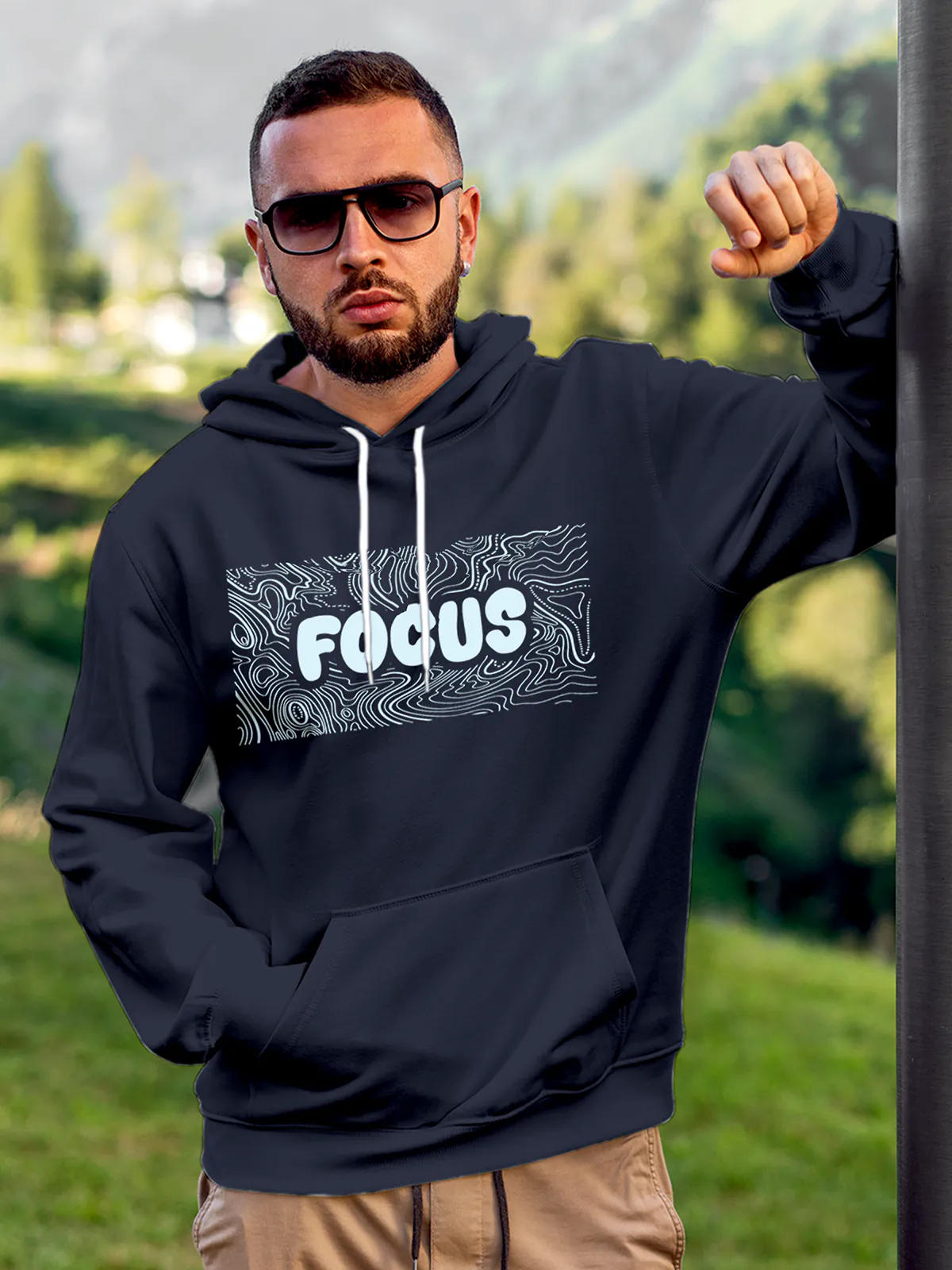 Model wearing Men's Navy Blue Hoodie Sweatshirt with 'Focus In Chaos' design, offering effortless style and premium comfort