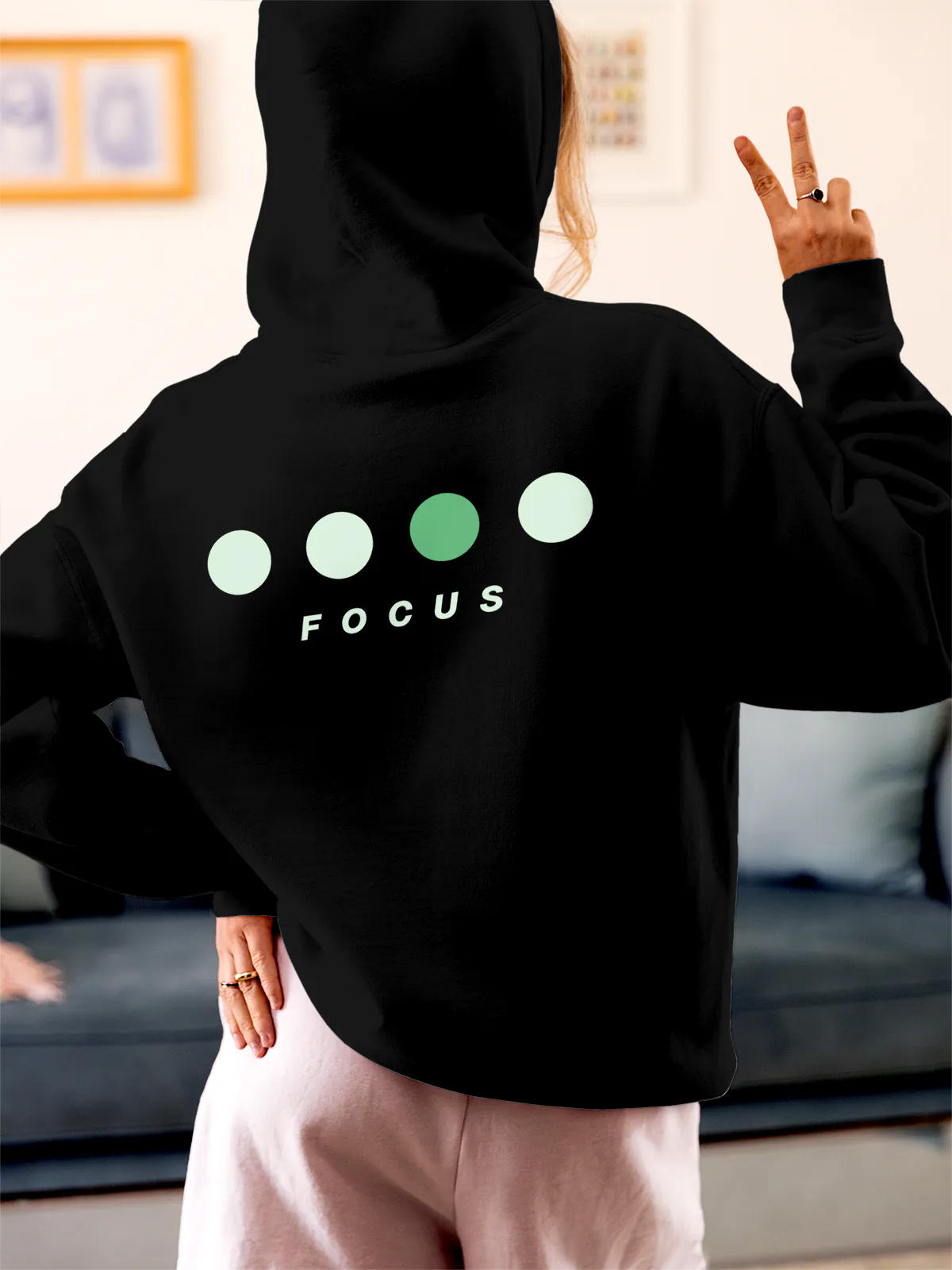 Model wearing Women's Black Hoodie Sweatshirt with 'Focus On Goal' design, offering effortless style and premium comfort