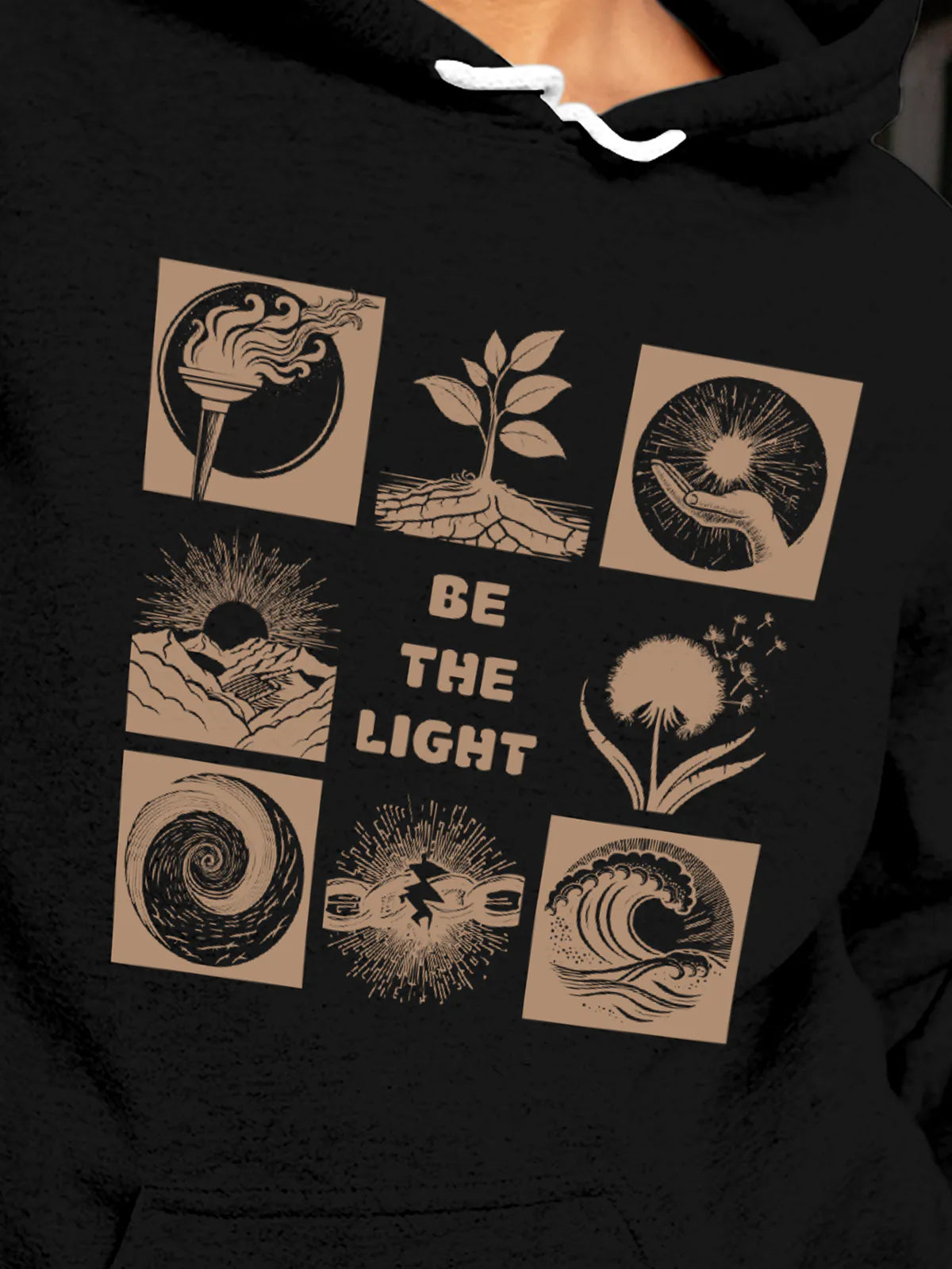 Close up of 'Be The Light' design on Women's Black Hoodie Sweatshirt, highlighting intricate details and vibrant print.