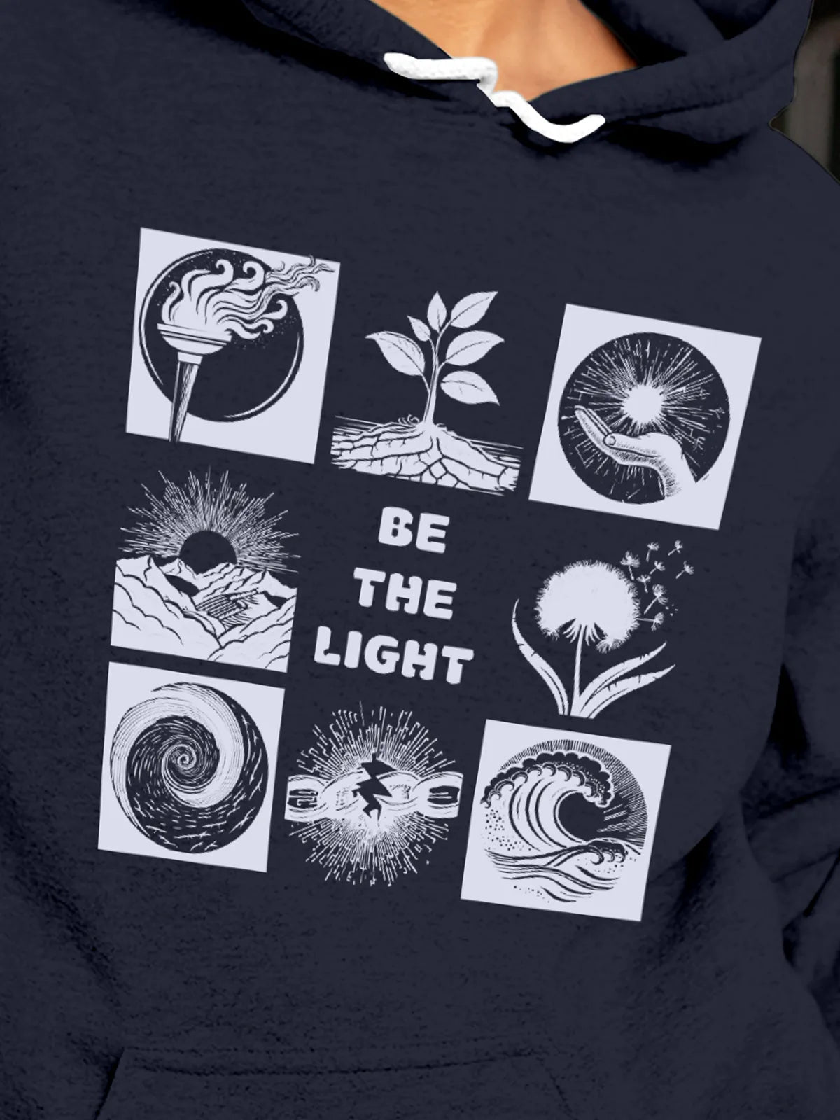 Close up of 'Be The Light' design on Women's Navy Blue Hoodie Sweatshirt, highlighting intricate details and vibrant print.