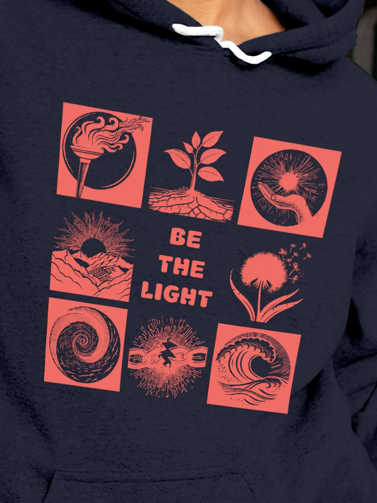Close up of 'Be The Light' design on Women's Navy Blue Hoodie Sweatshirt, highlighting intricate details and vibrant print.