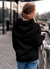 Back view of Fighterhero Women's Black Hoodie Sweatshirt, highlighting the modern look and clean finish