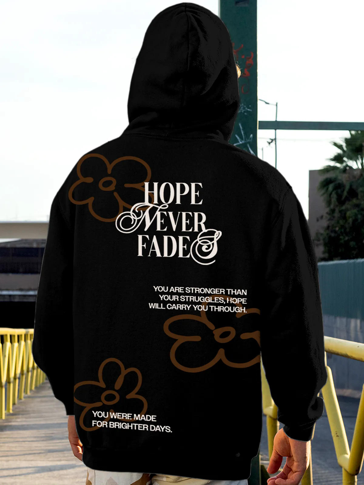 Model wearing Men's Black Hoodie Sweatshirt with 'Hope Never Fades' design, offering effortless style and premium comfort
